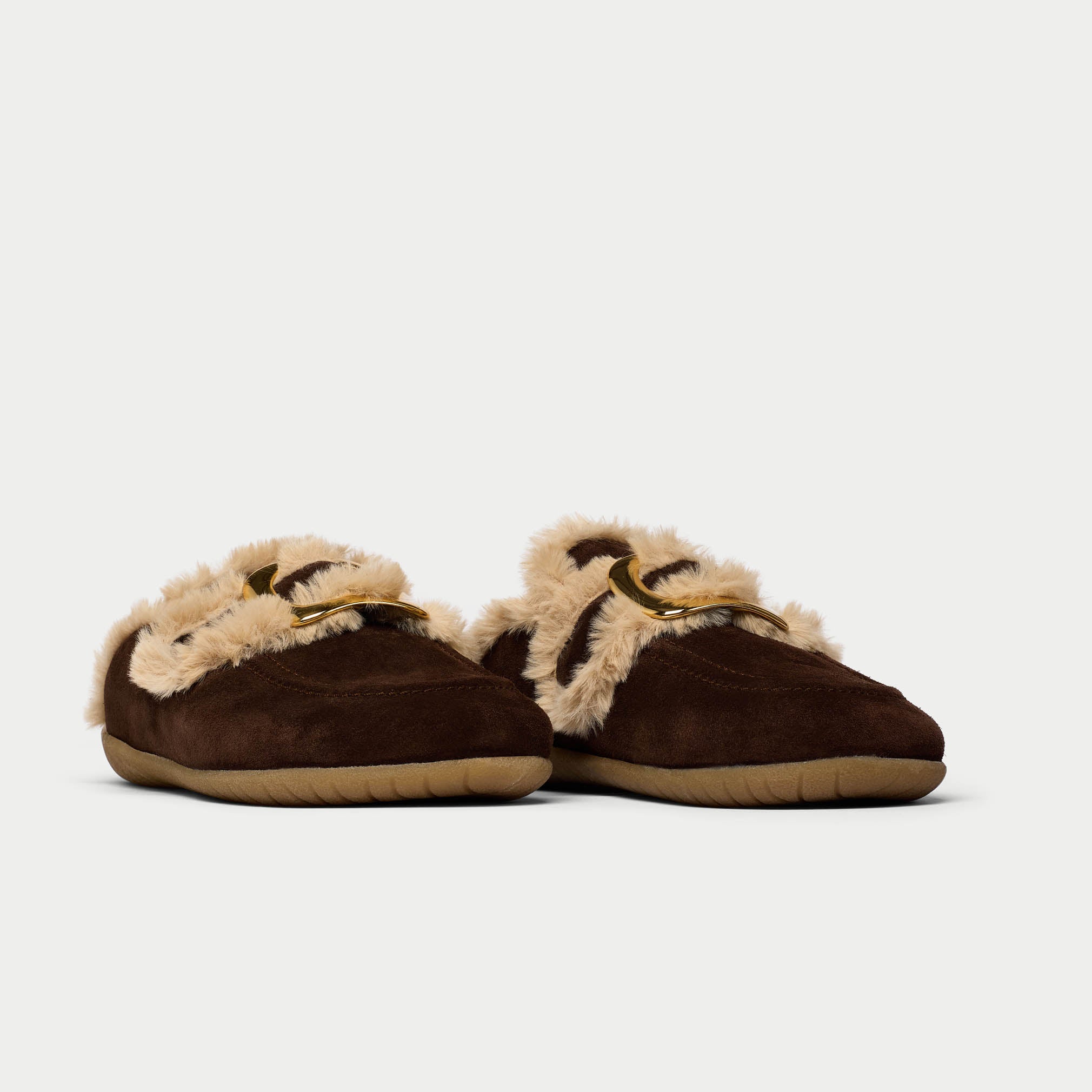 Pair of brown slippers with beige fur trim on a white background