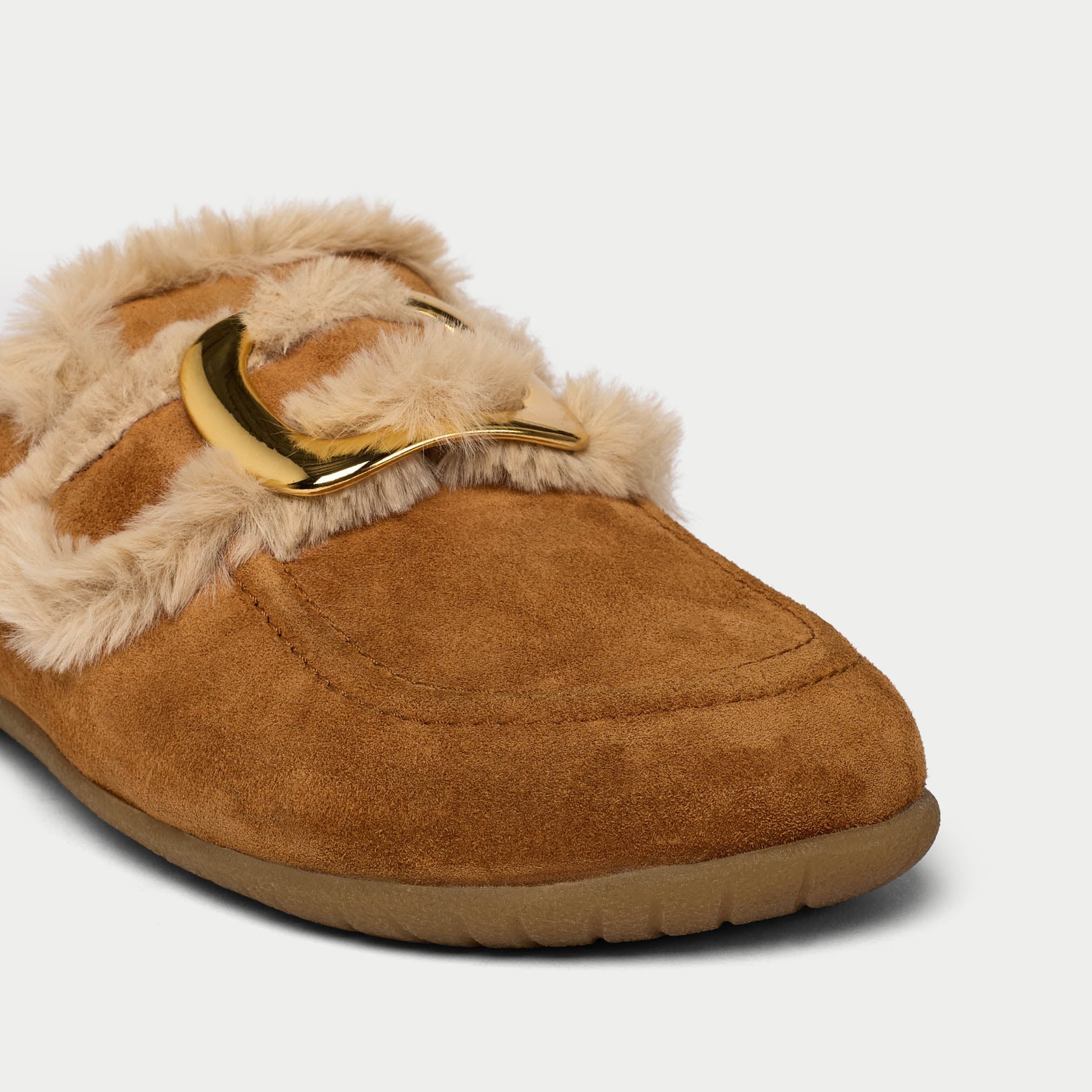 Brown slipper with fur trim and gold buckle on a light gray background