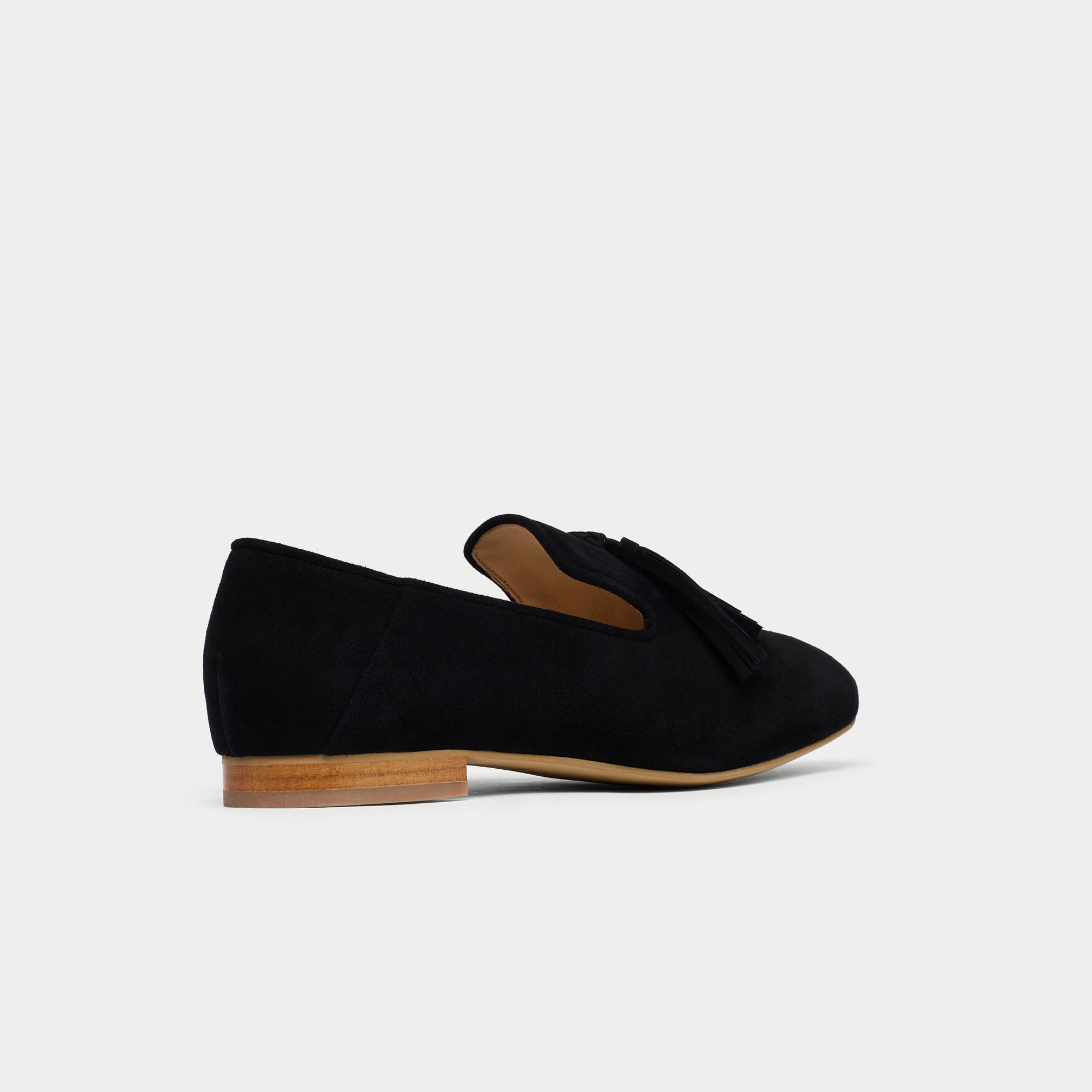 Black loafers on a light gray background