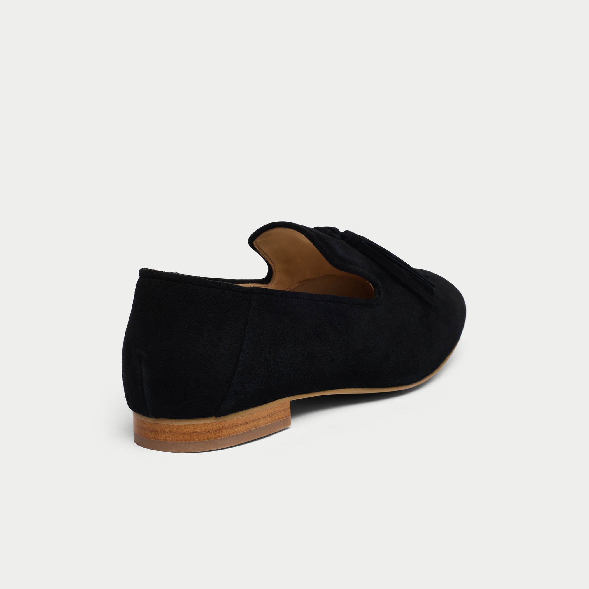 Black loafer shoe on a light gray background