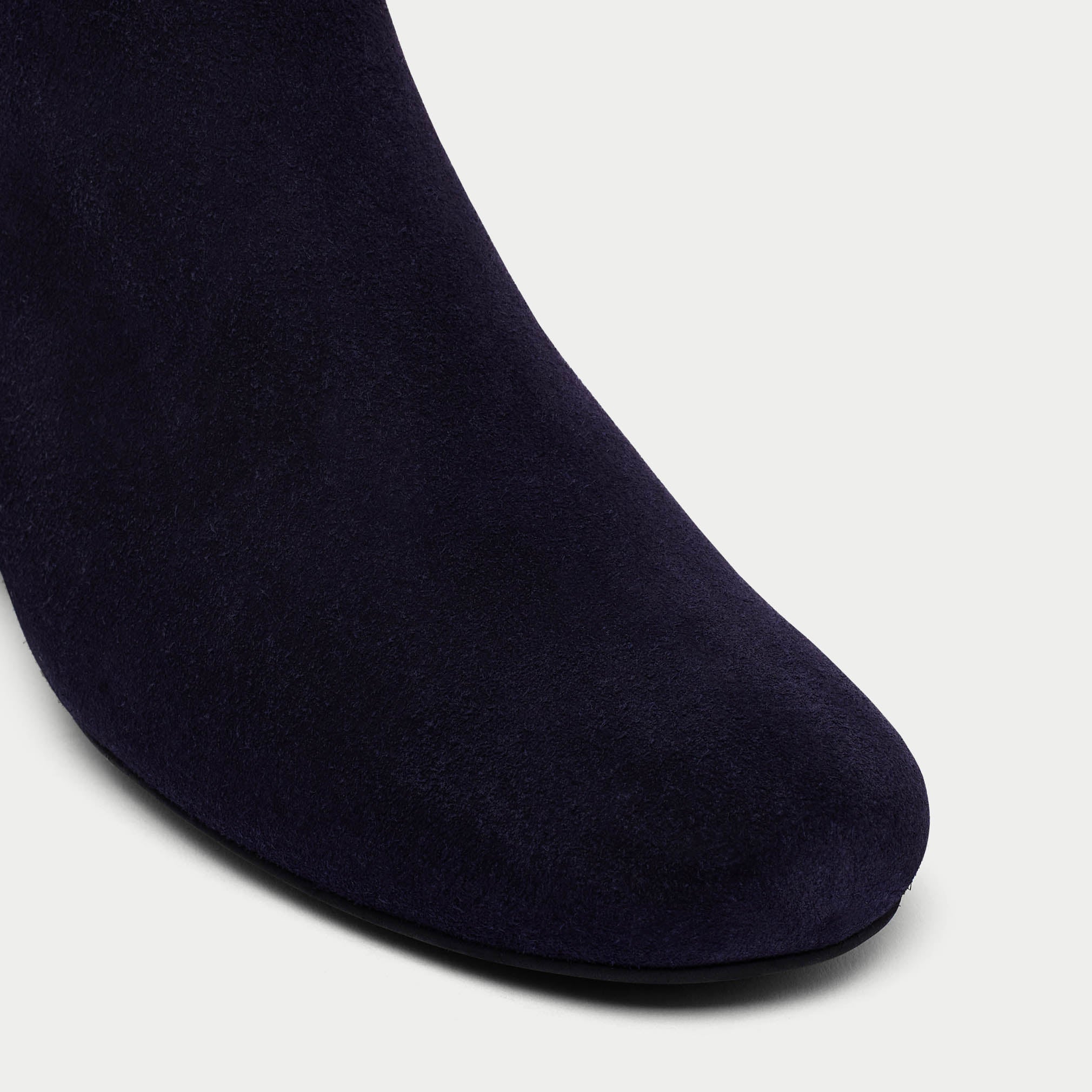 Navy blue sock on a light gray background