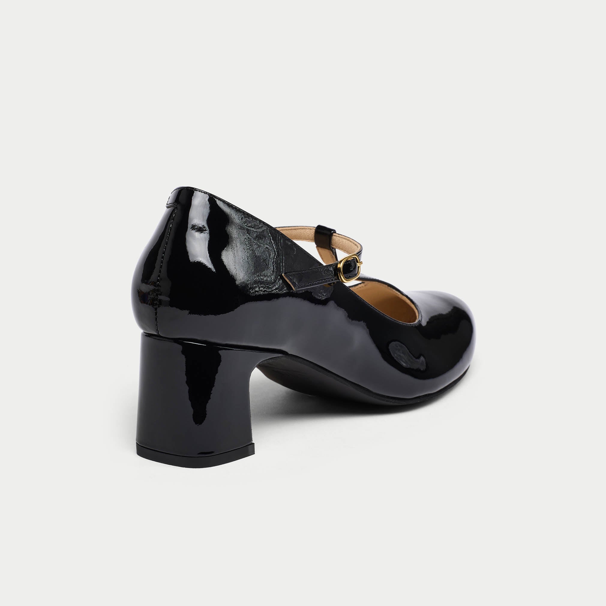 Black patent leather shoe on a white background