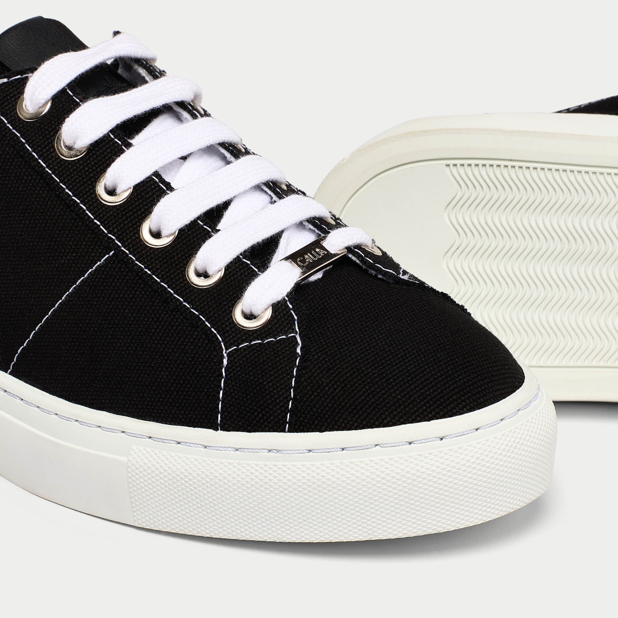 Luna black trainer shoe tip view