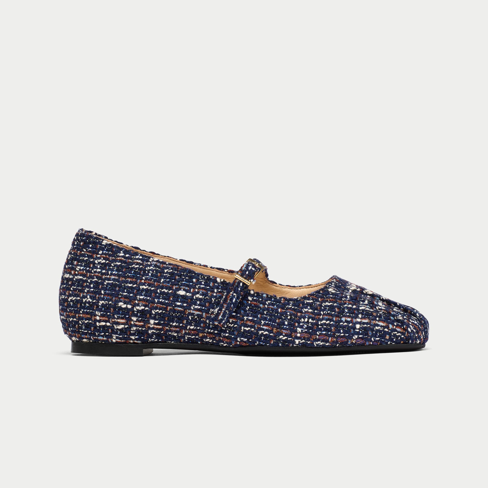 Navy blue tweed flat shoe on a light gray background
