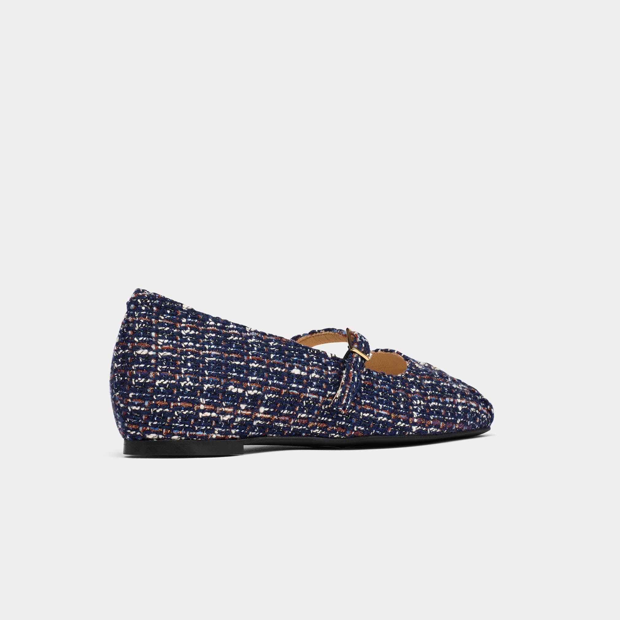 Tweed flat shoe on a light gray background