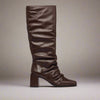Brown knee-high boot on a light gray background