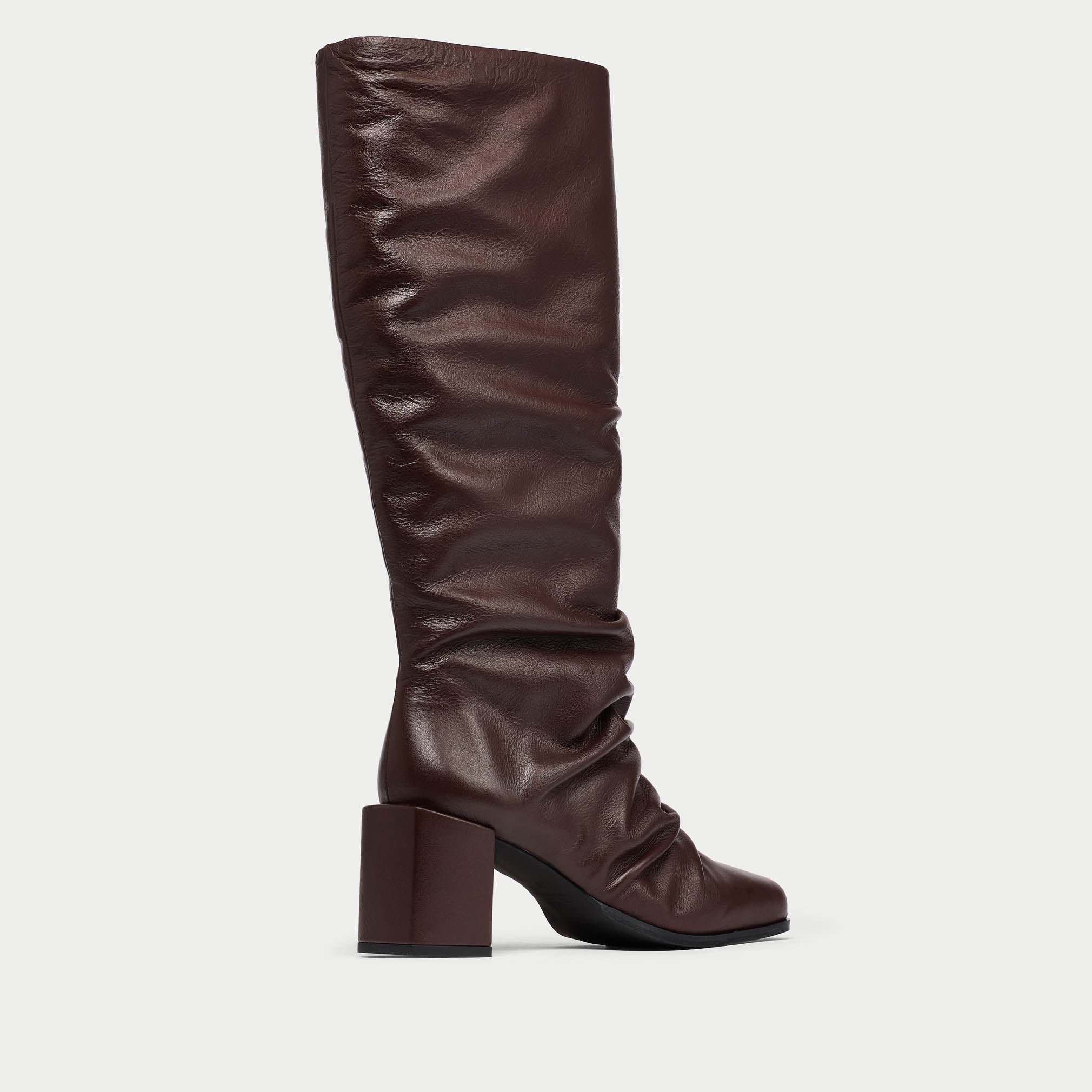 Brown knee-high boot with a block heel on a light gray background