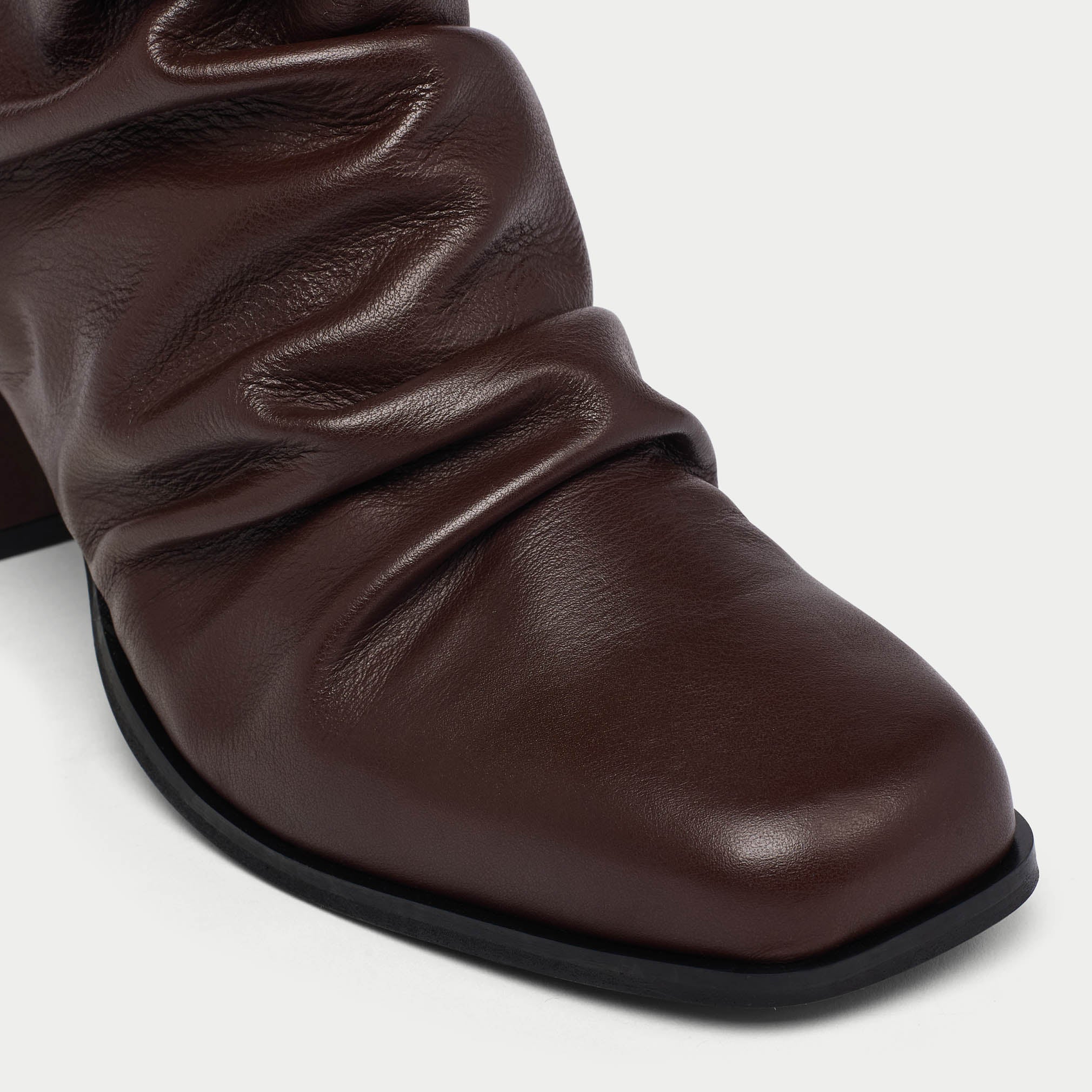 Brown leather boot on a white background