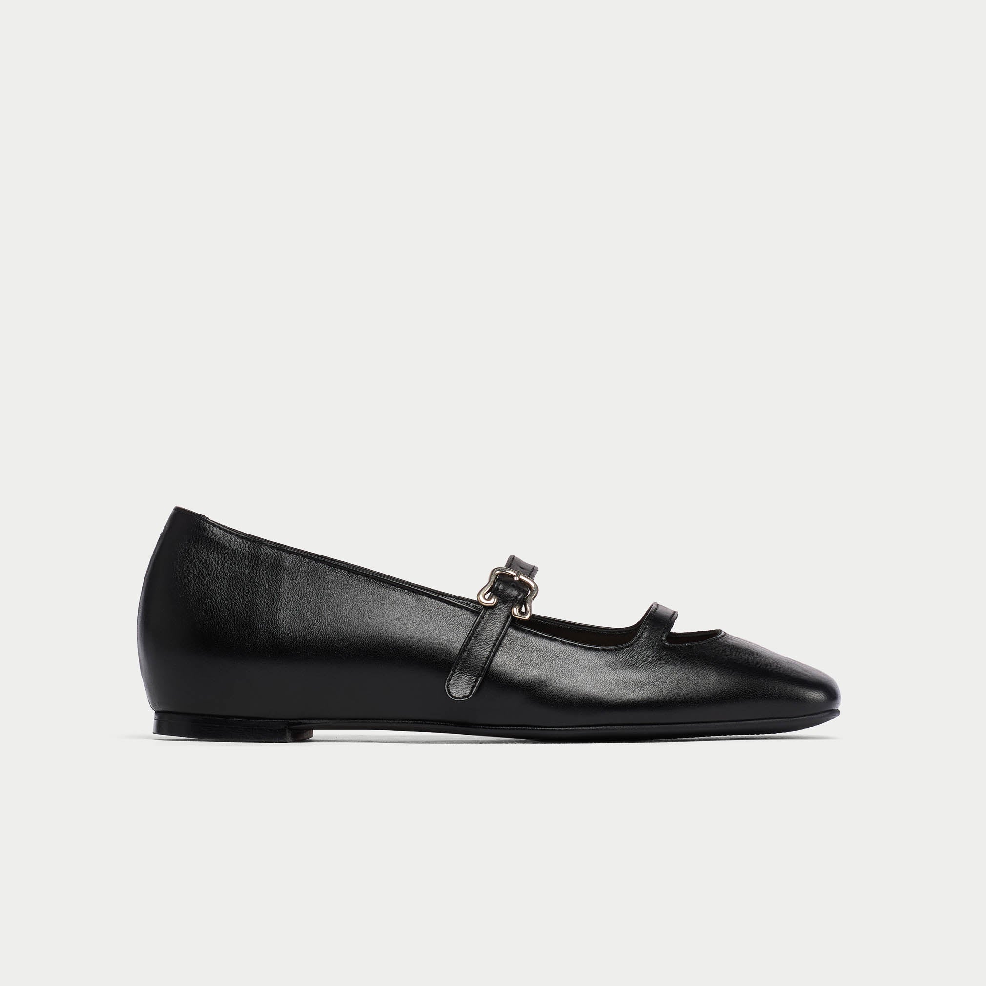 Black platform shoe with a strap on a white background