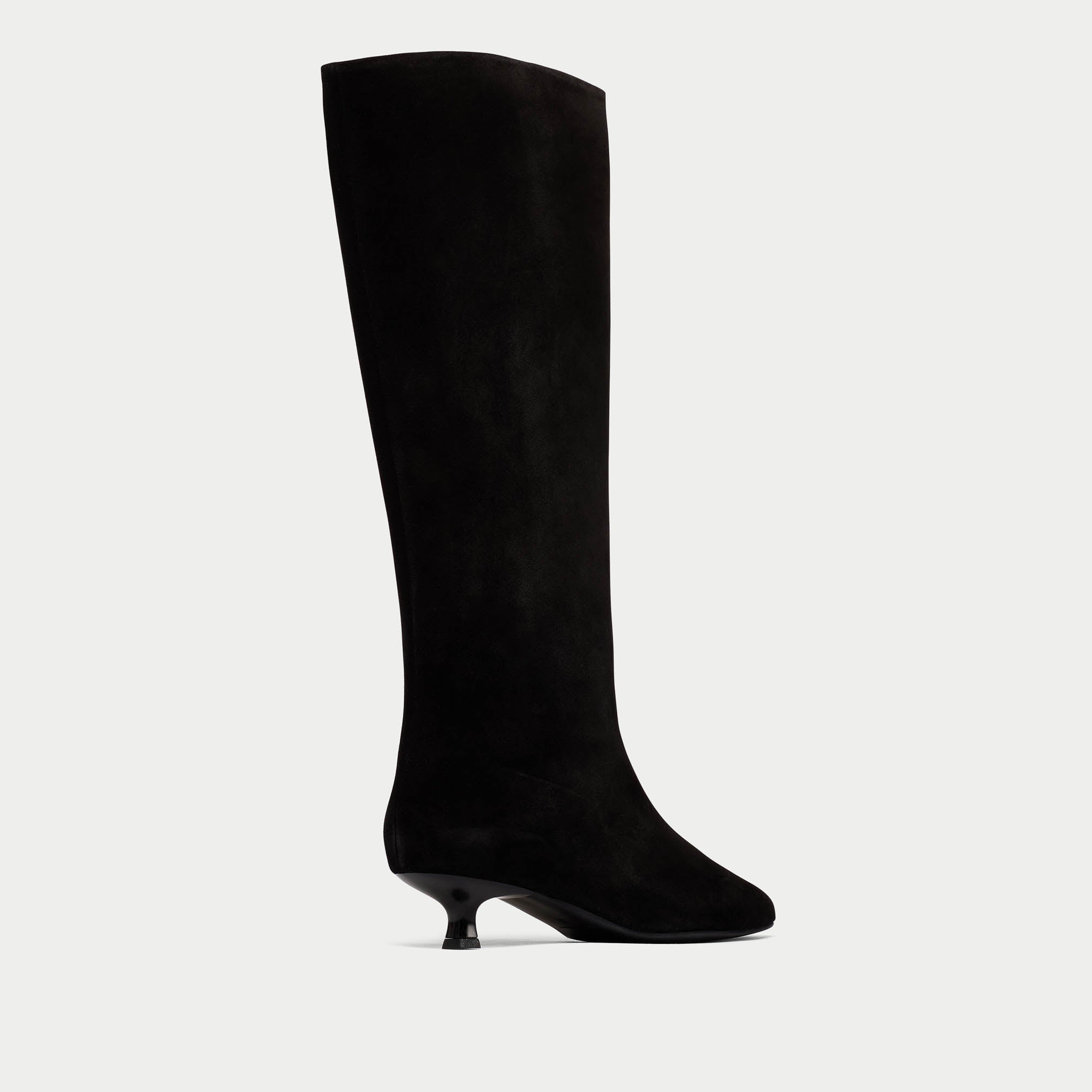Black knee-high boot on a light gray background