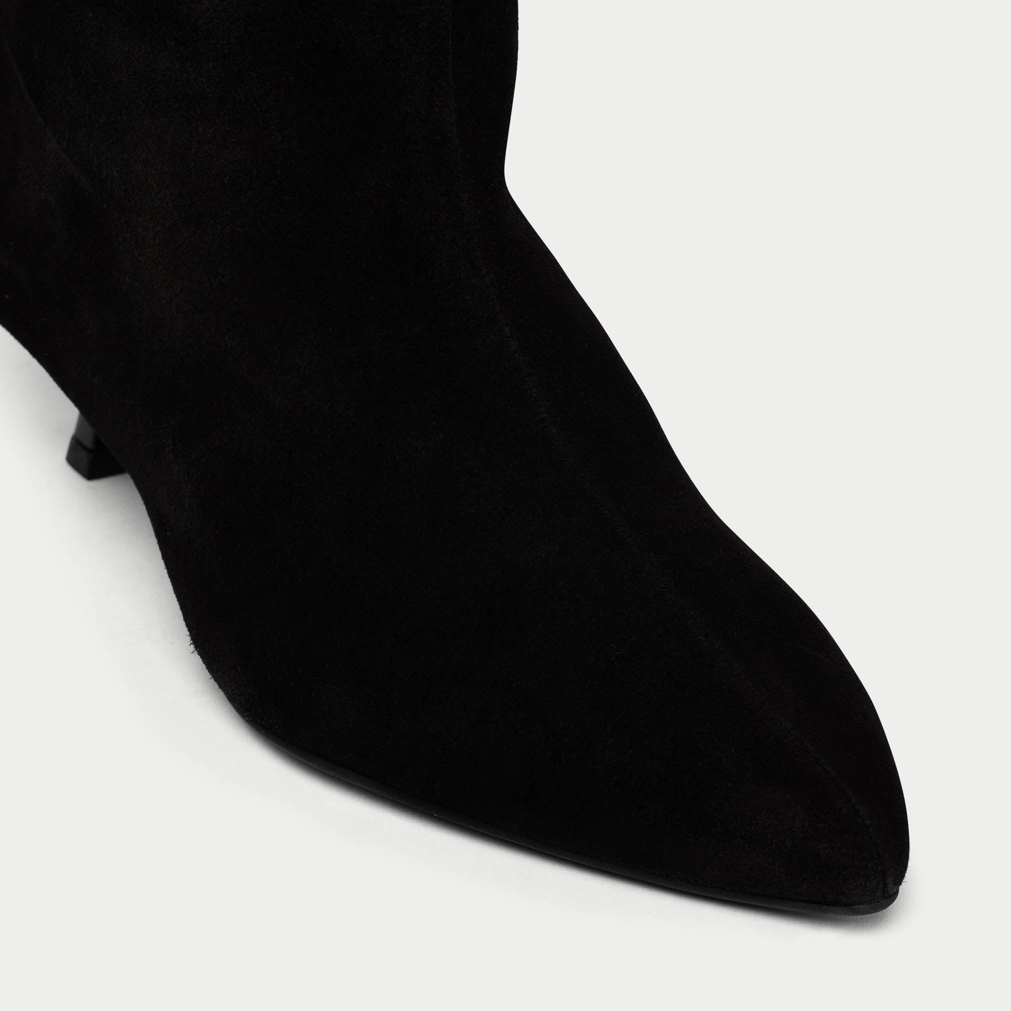 Black sock boot on a white background