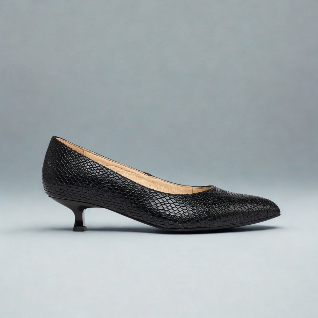 Black high-heeled shoe on a gray background