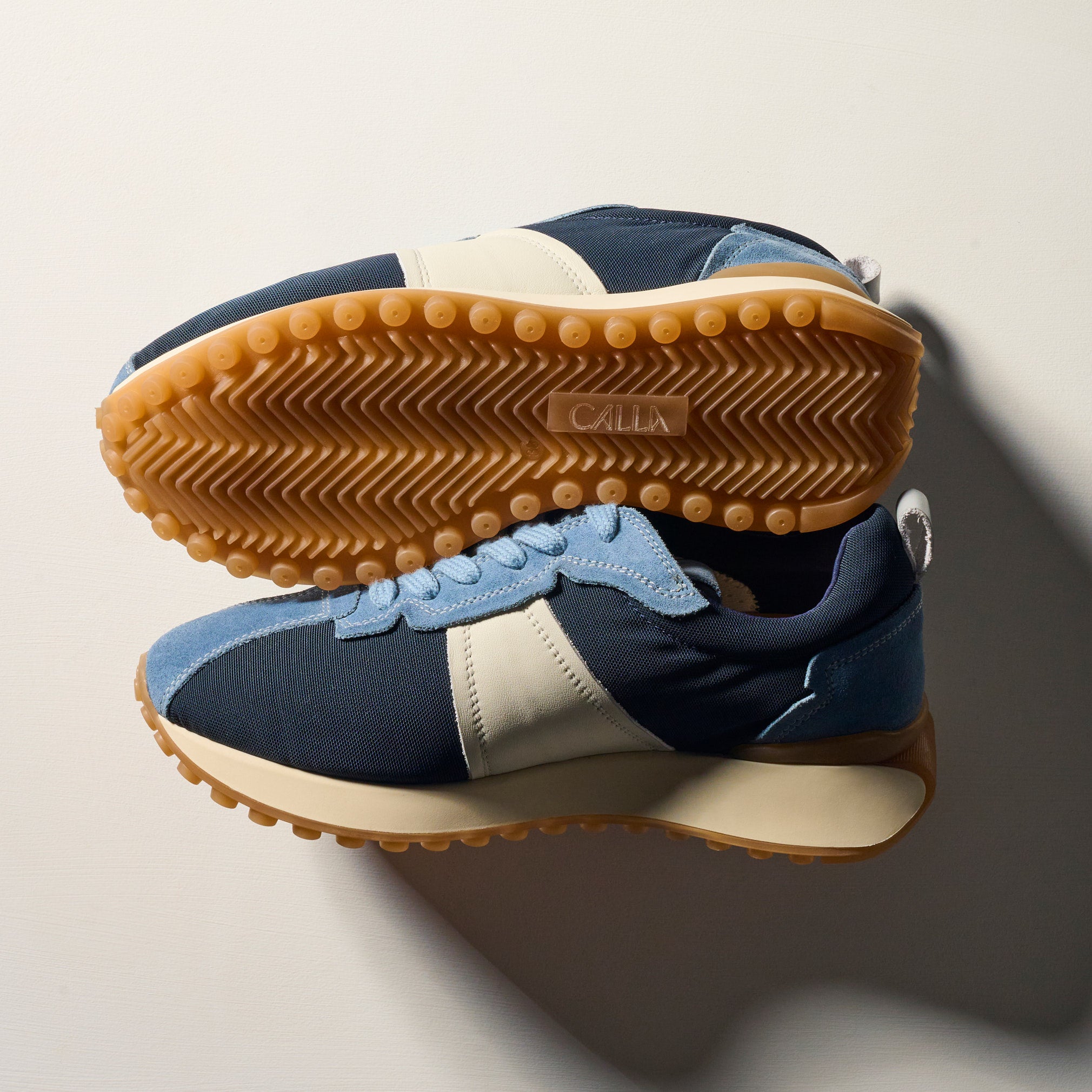 cosmos sneaker with beige sole on a neutral background