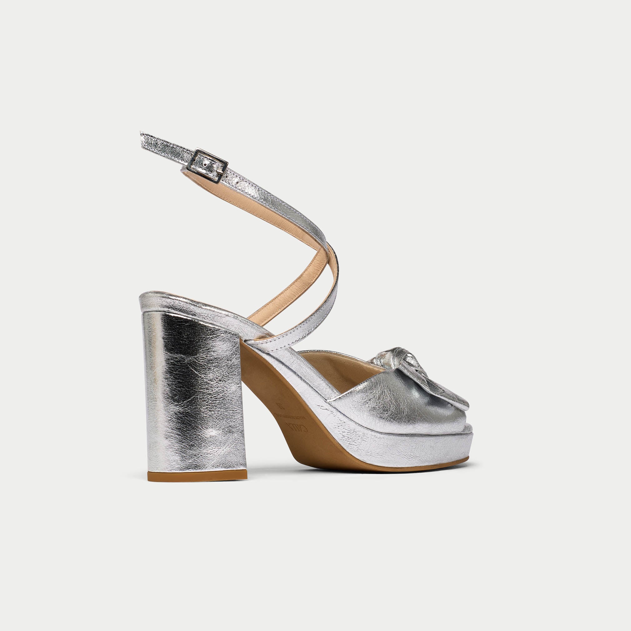 Silver high-heeled sandal on a white background