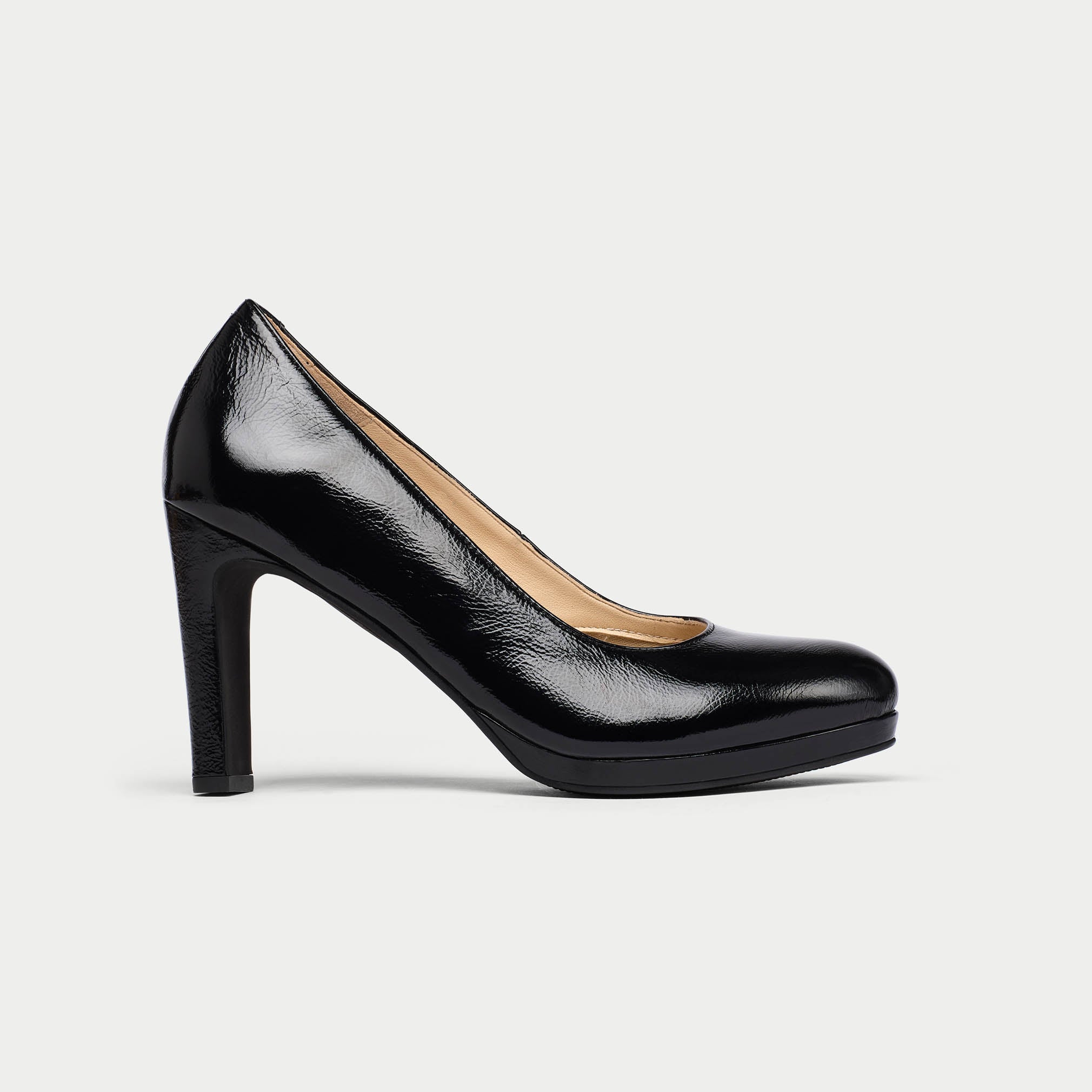 Black high-heeled shoe on a light gray background