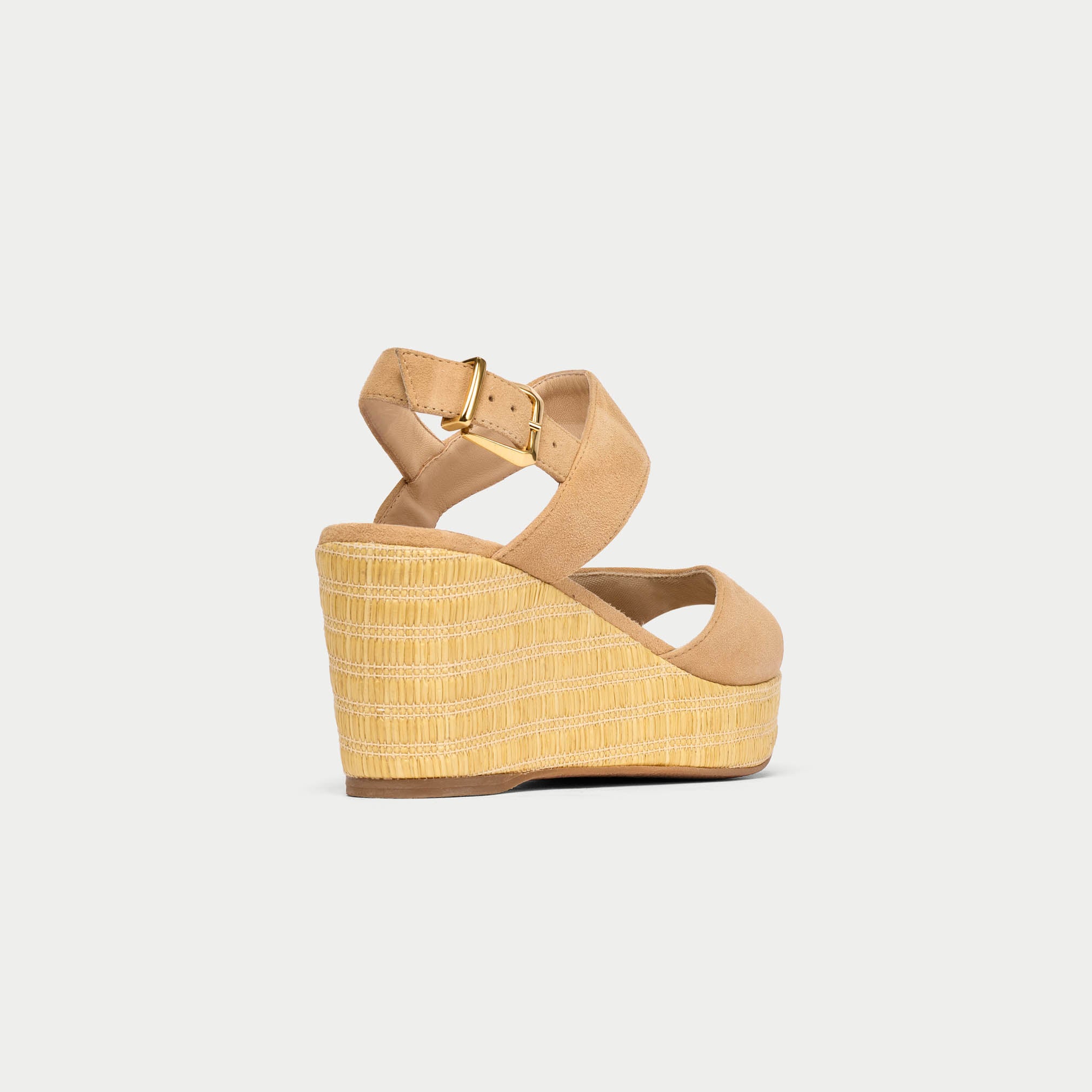 Beige wedge sandal with a straw-like texture on a light gray background