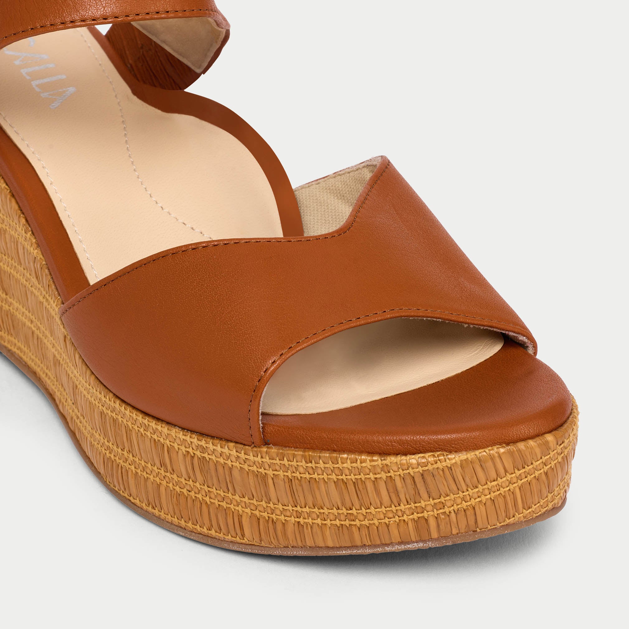 Brown wedge sandal on a white background
