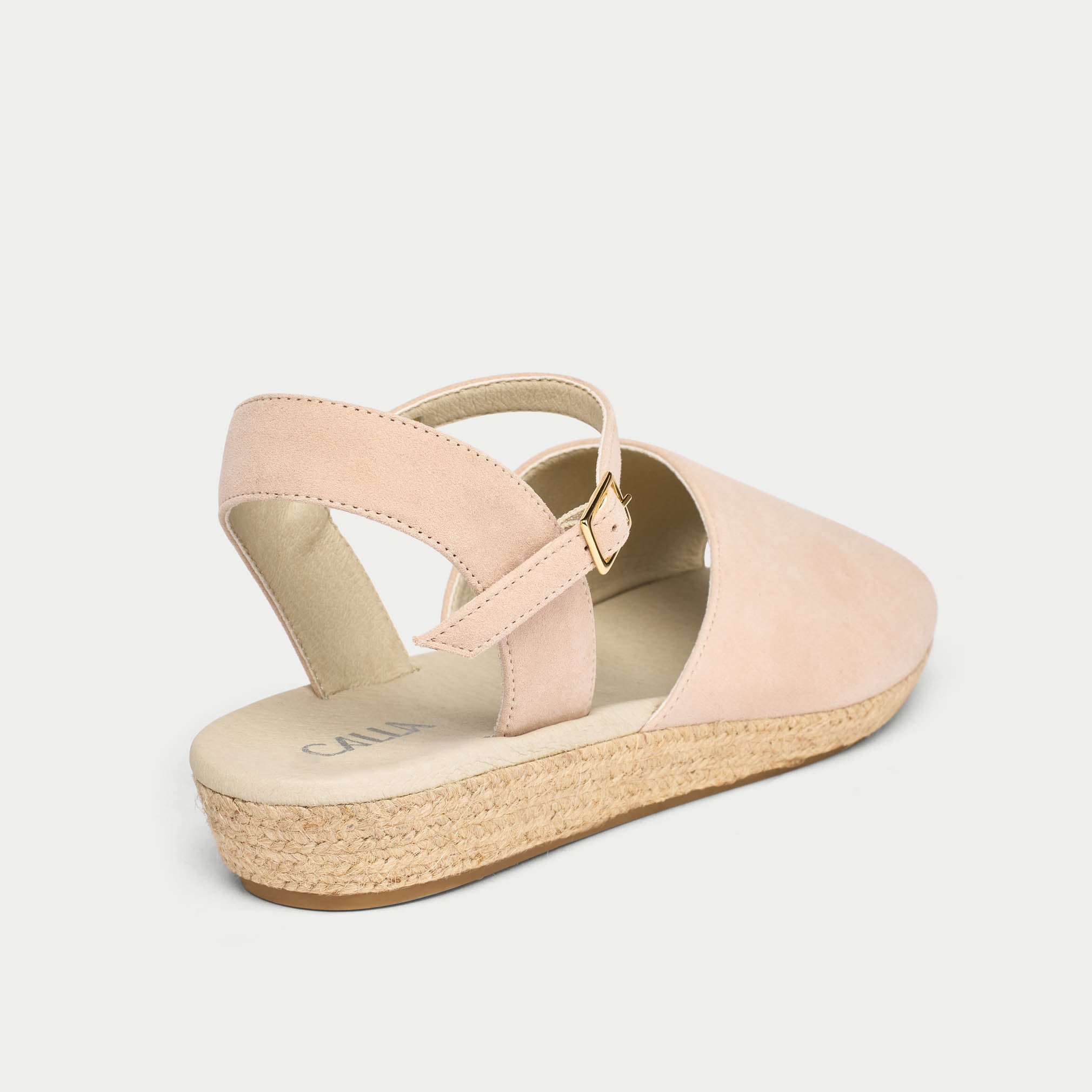 Pink sandal with a woven sole on a light gray background