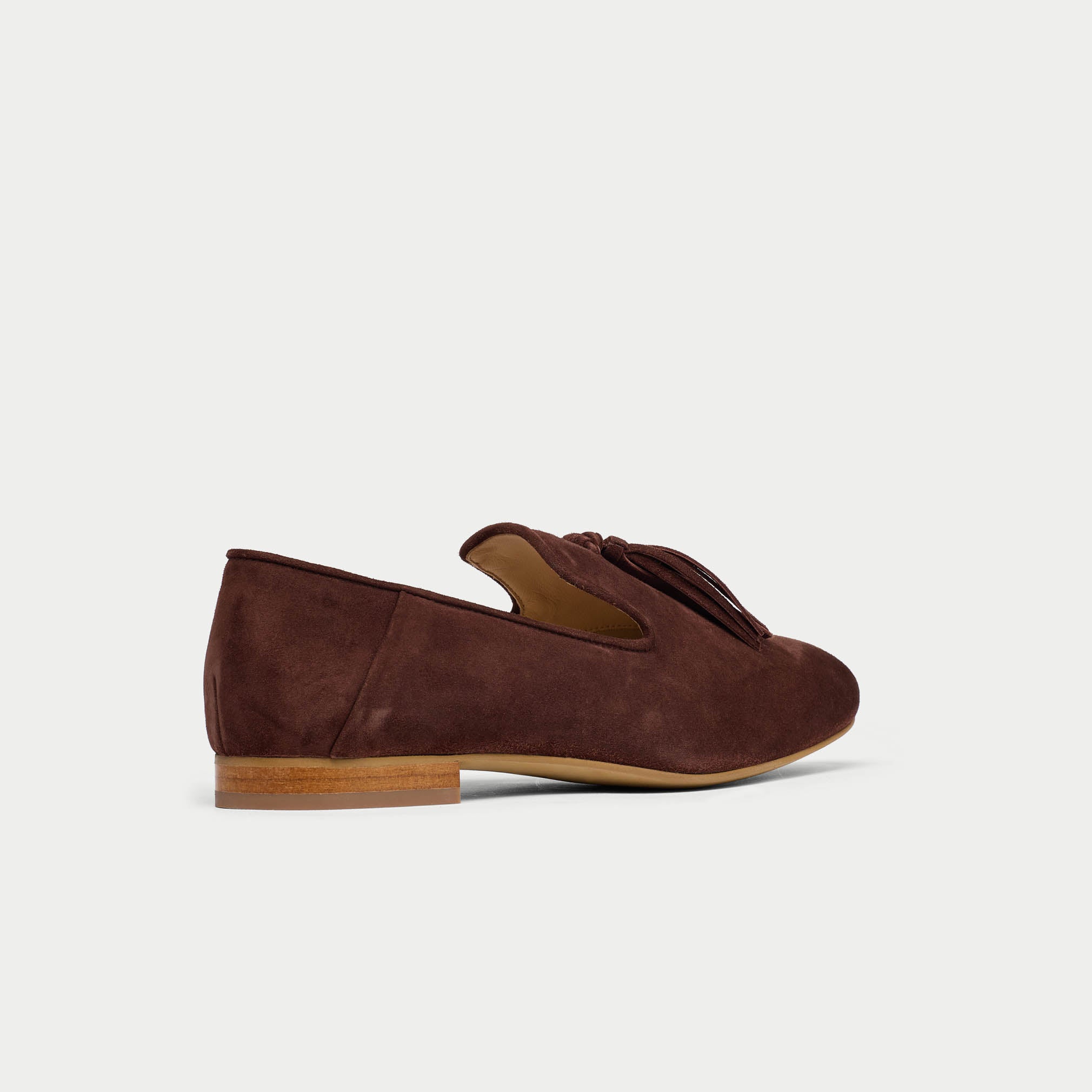 Brown suede loafer shoe on a light gray background