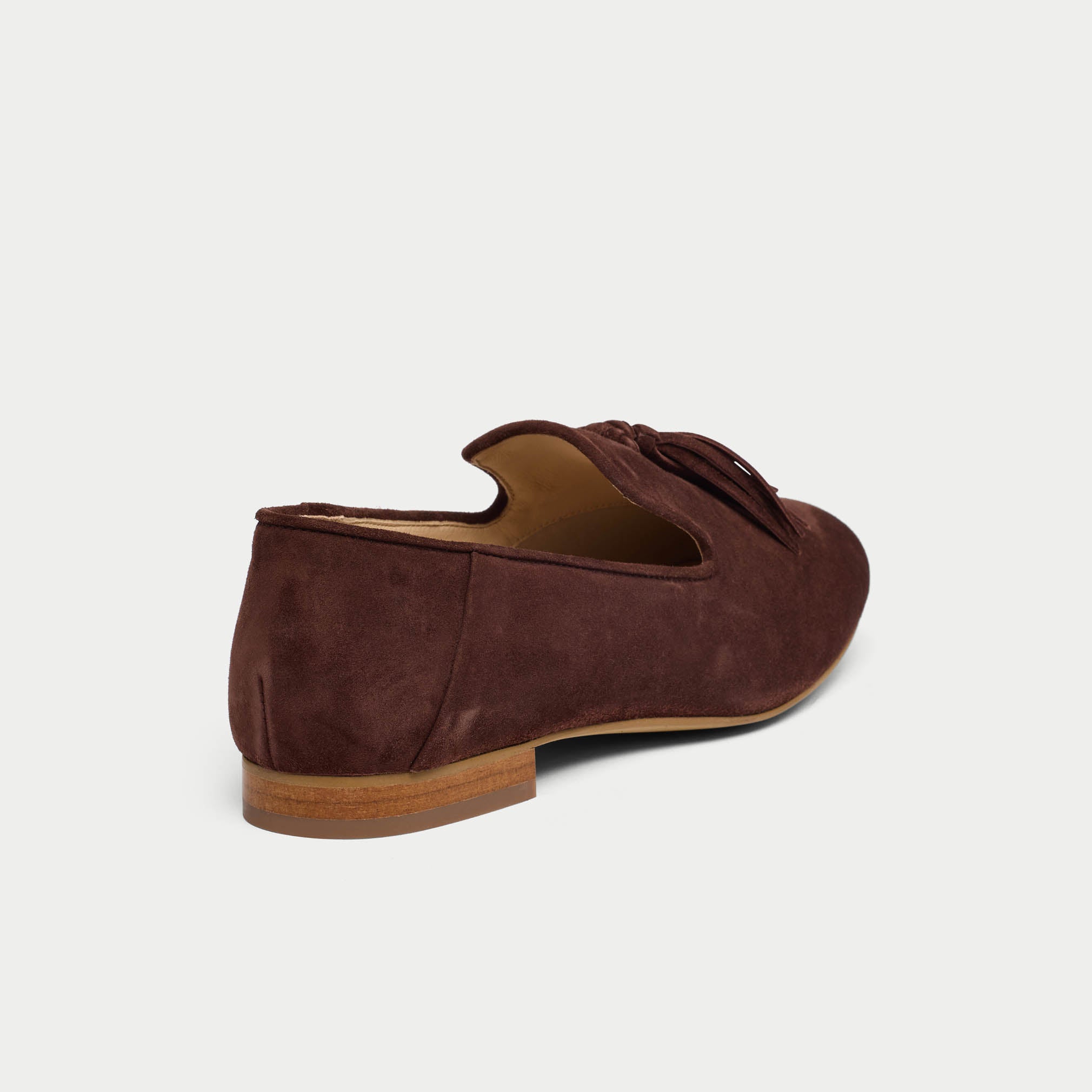 Brown suede loafer shoe on a light gray background