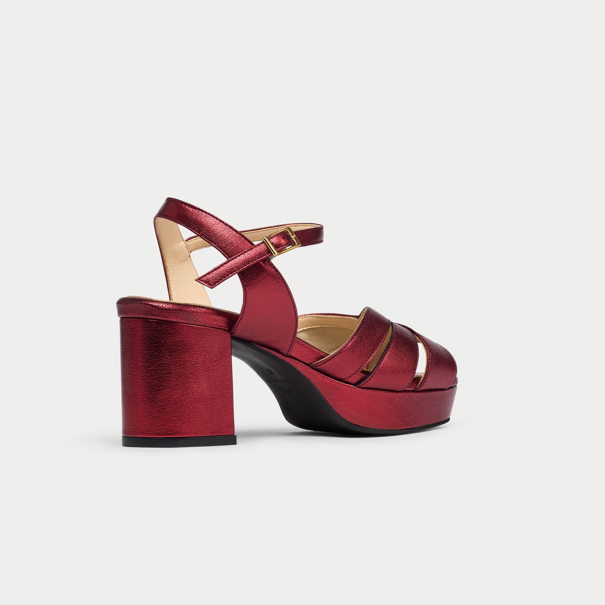 Red high-heeled sandal on a light gray background