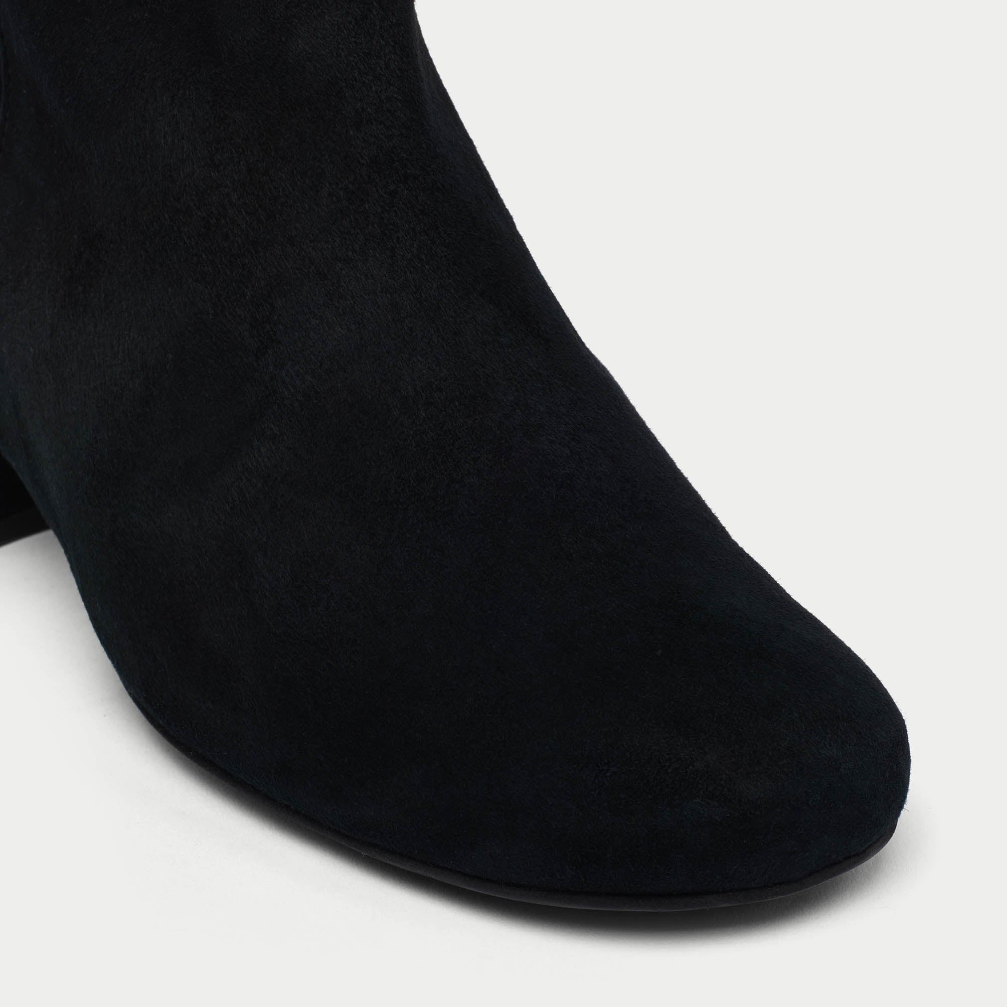 Lexie black ankle boots on a light gray background tip close-up