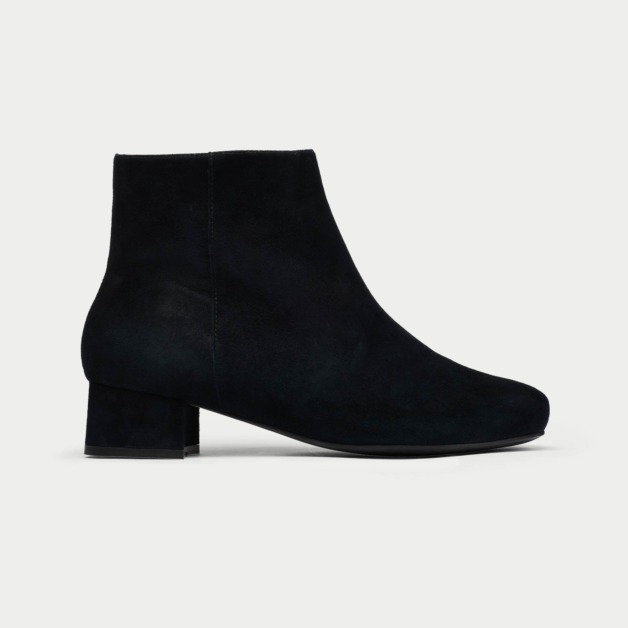 Black Lexie suede ankle boot on a light gray background