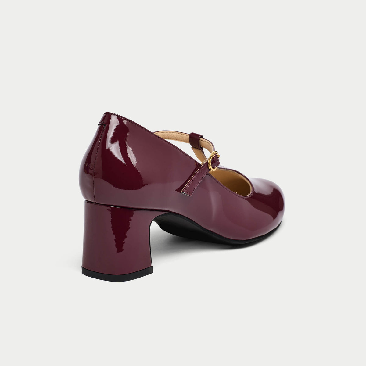 Shiny purple shoe with a block heel on a light gray background