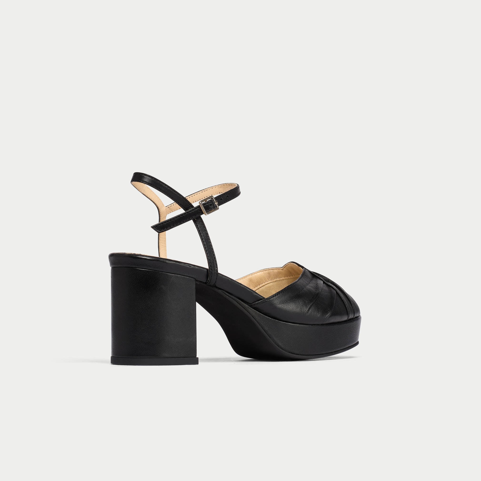 Black high-heeled sandal on a light gray background