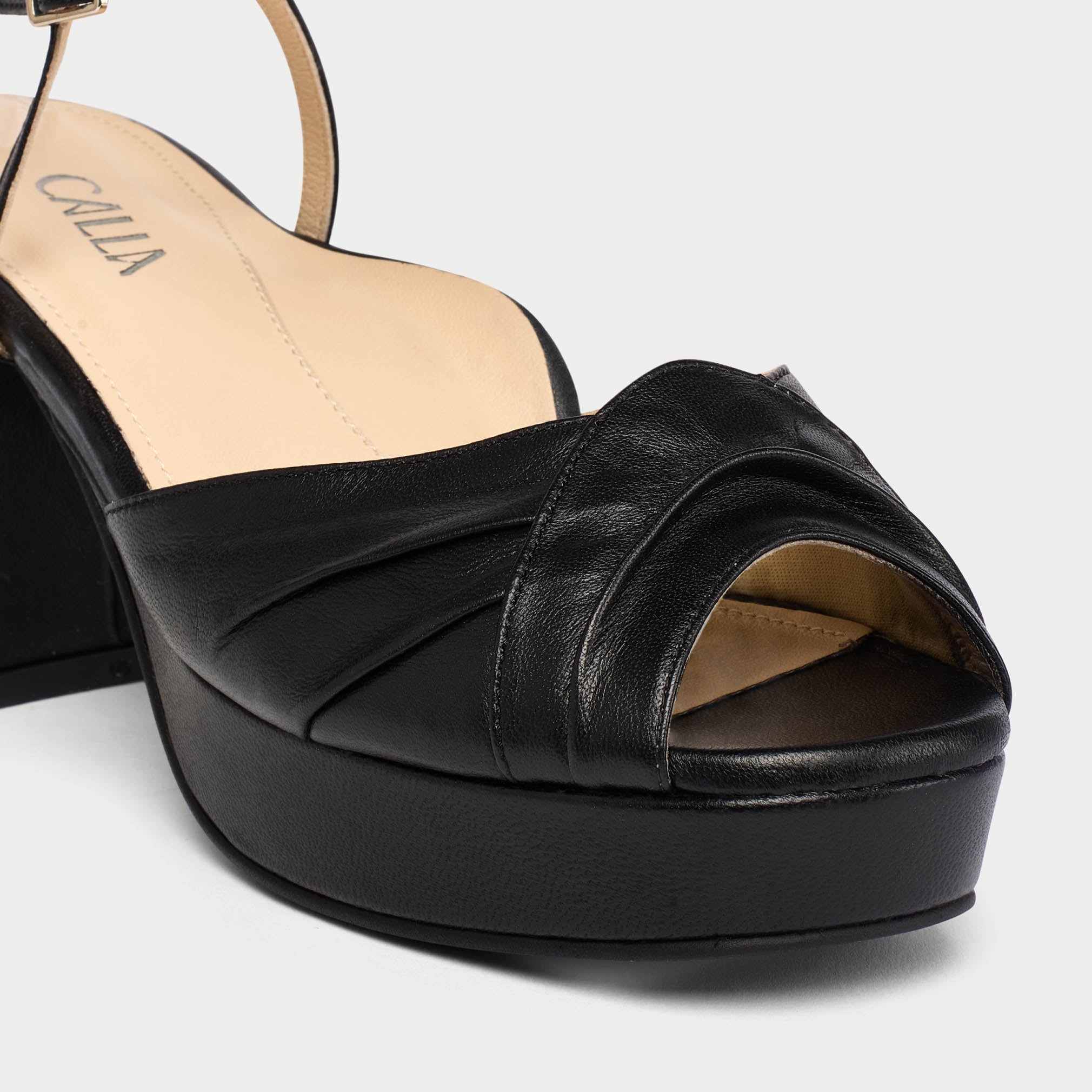 Black platform sandal on a white background