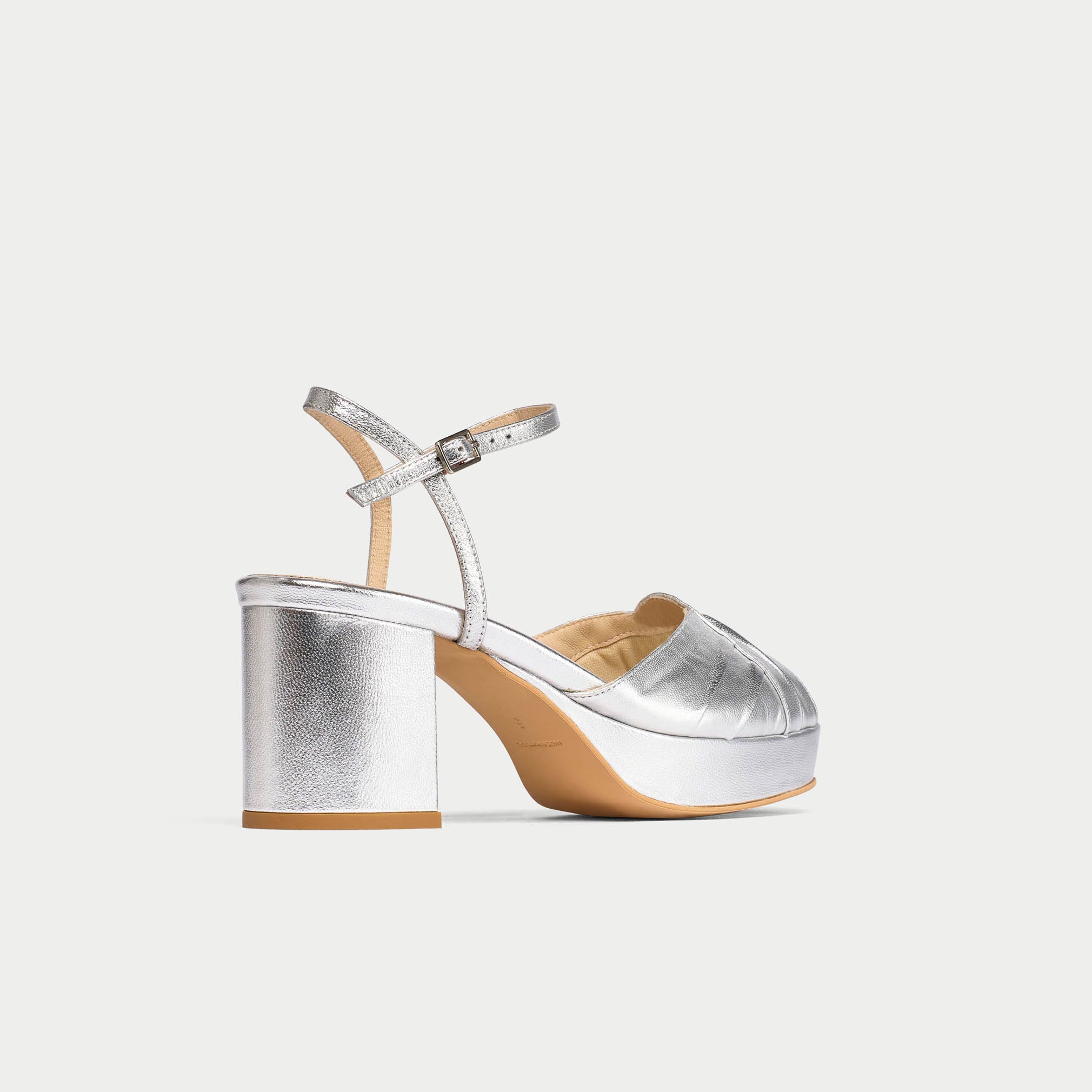 Silver high-heeled sandal on a white background