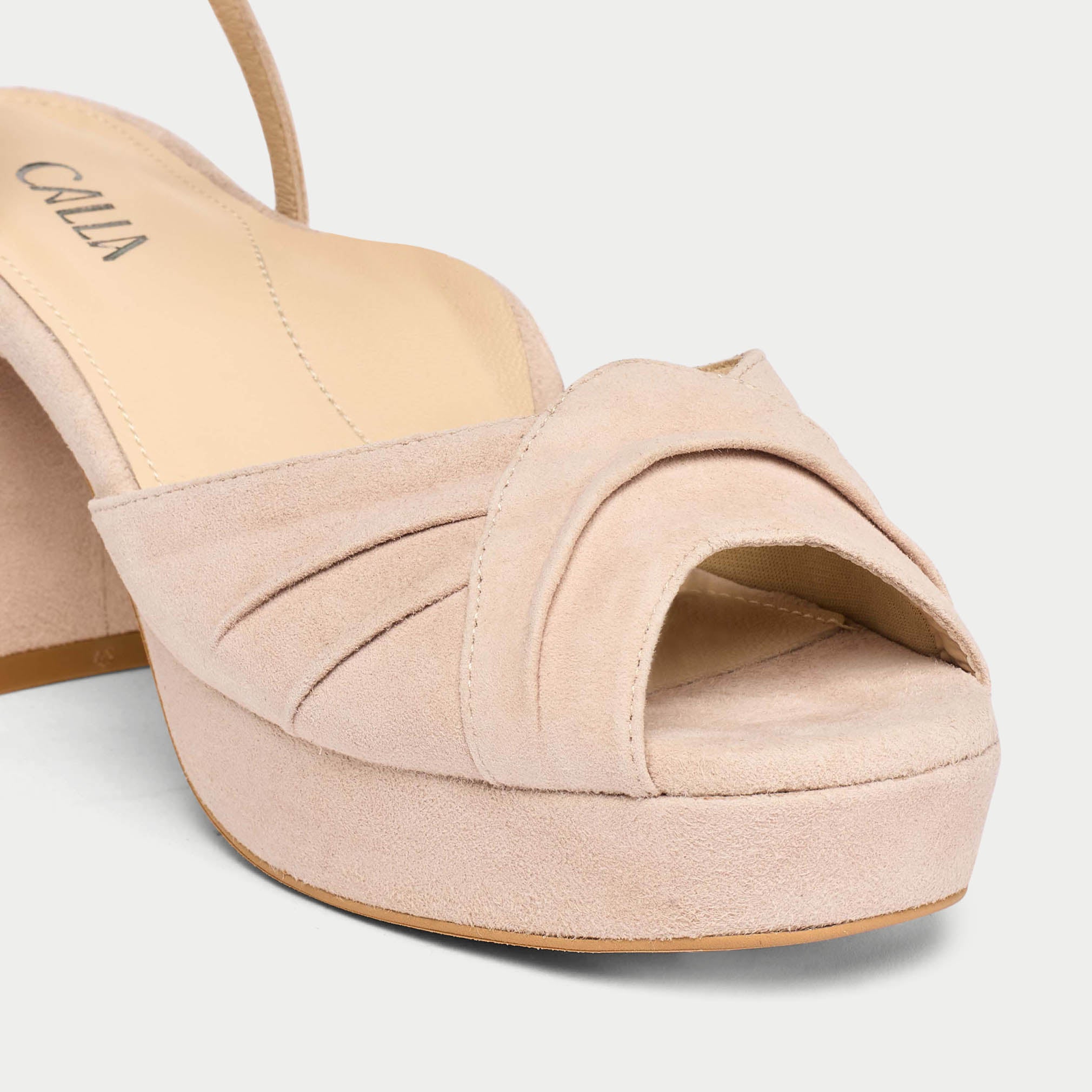 Beige high-heeled sandal with open toe on a light gray background