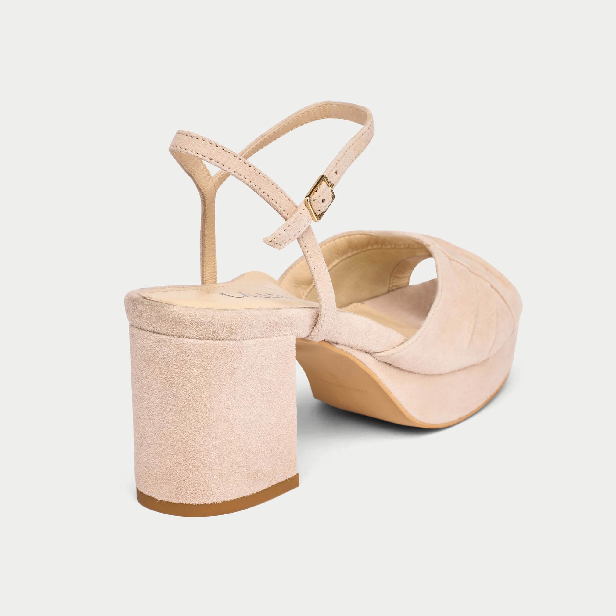 Beige wedge sandals on a light gray background