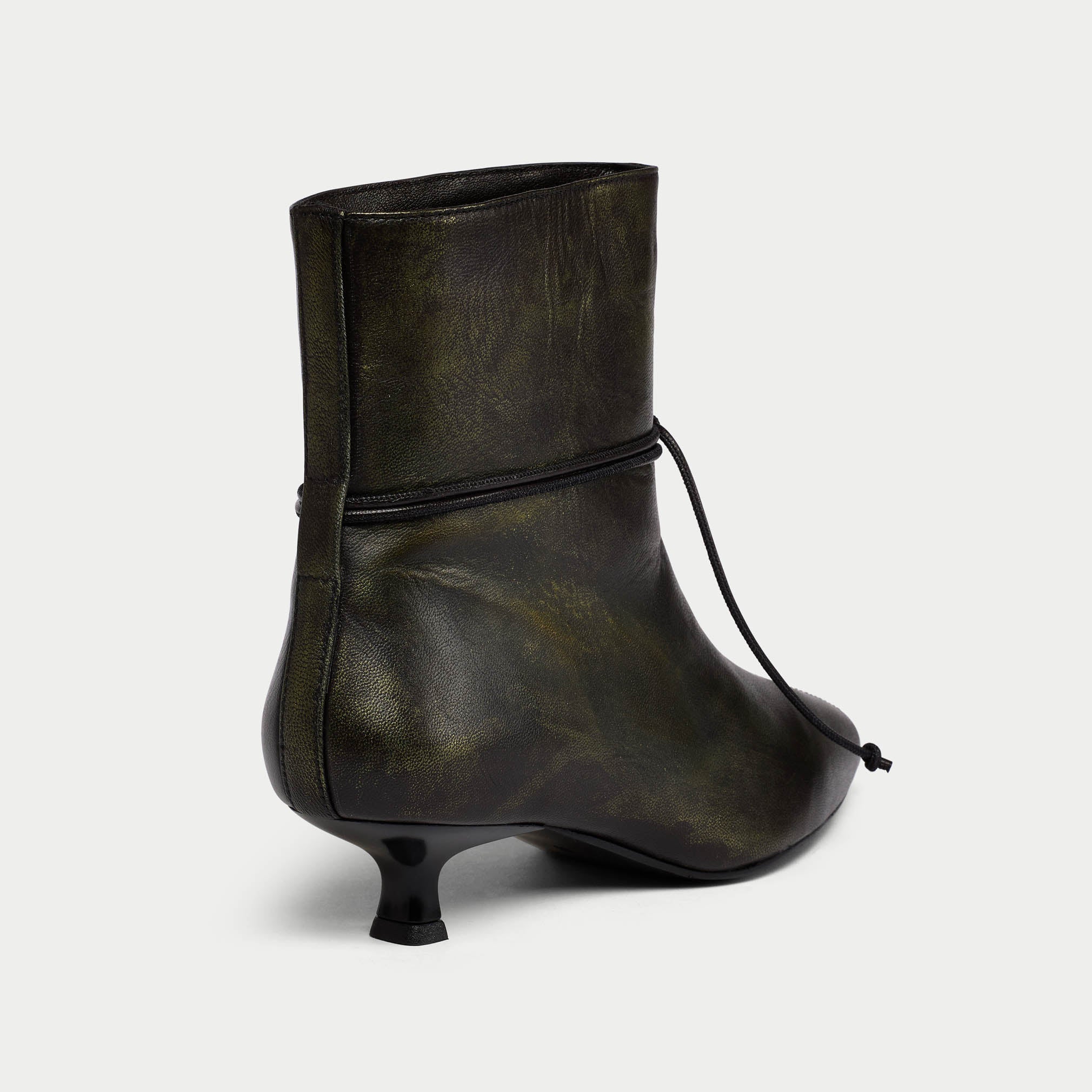 Black leather ankle boot with a slight heel on a light gray background