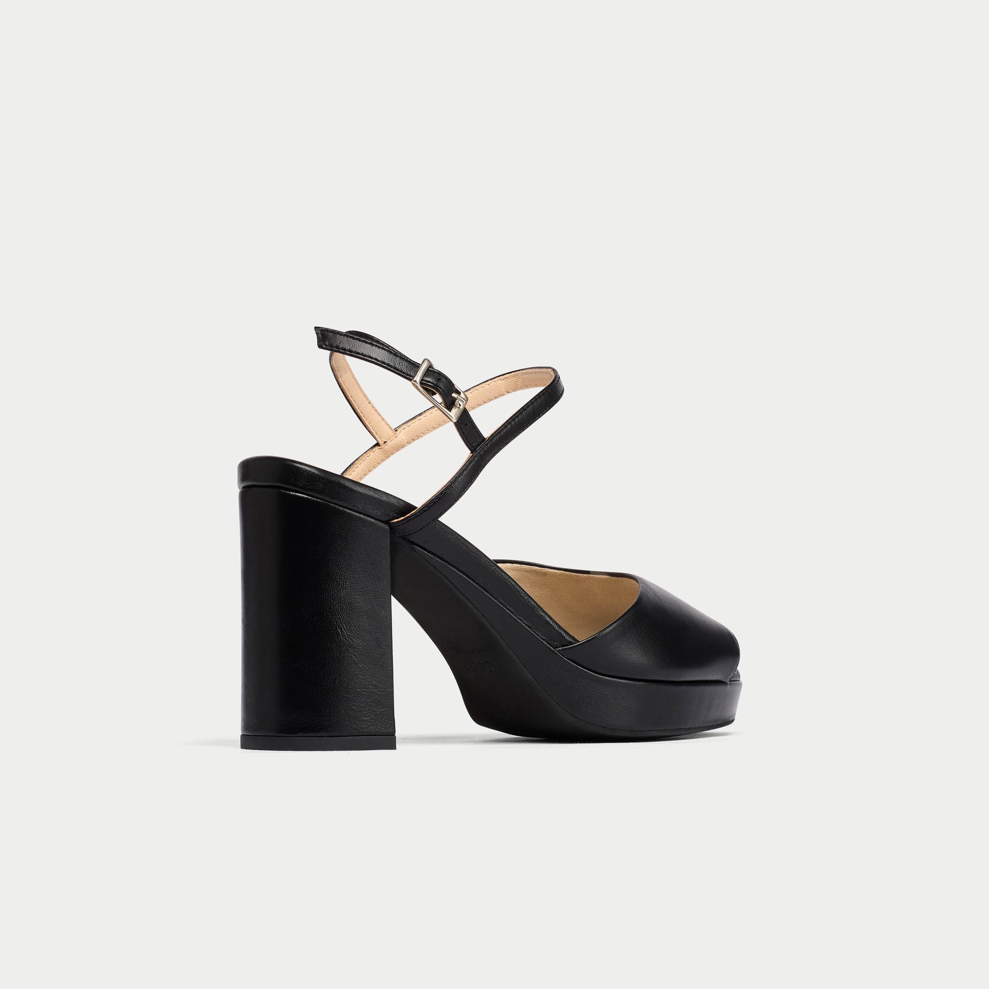 Black platform sandal with a block heel on a light gray background