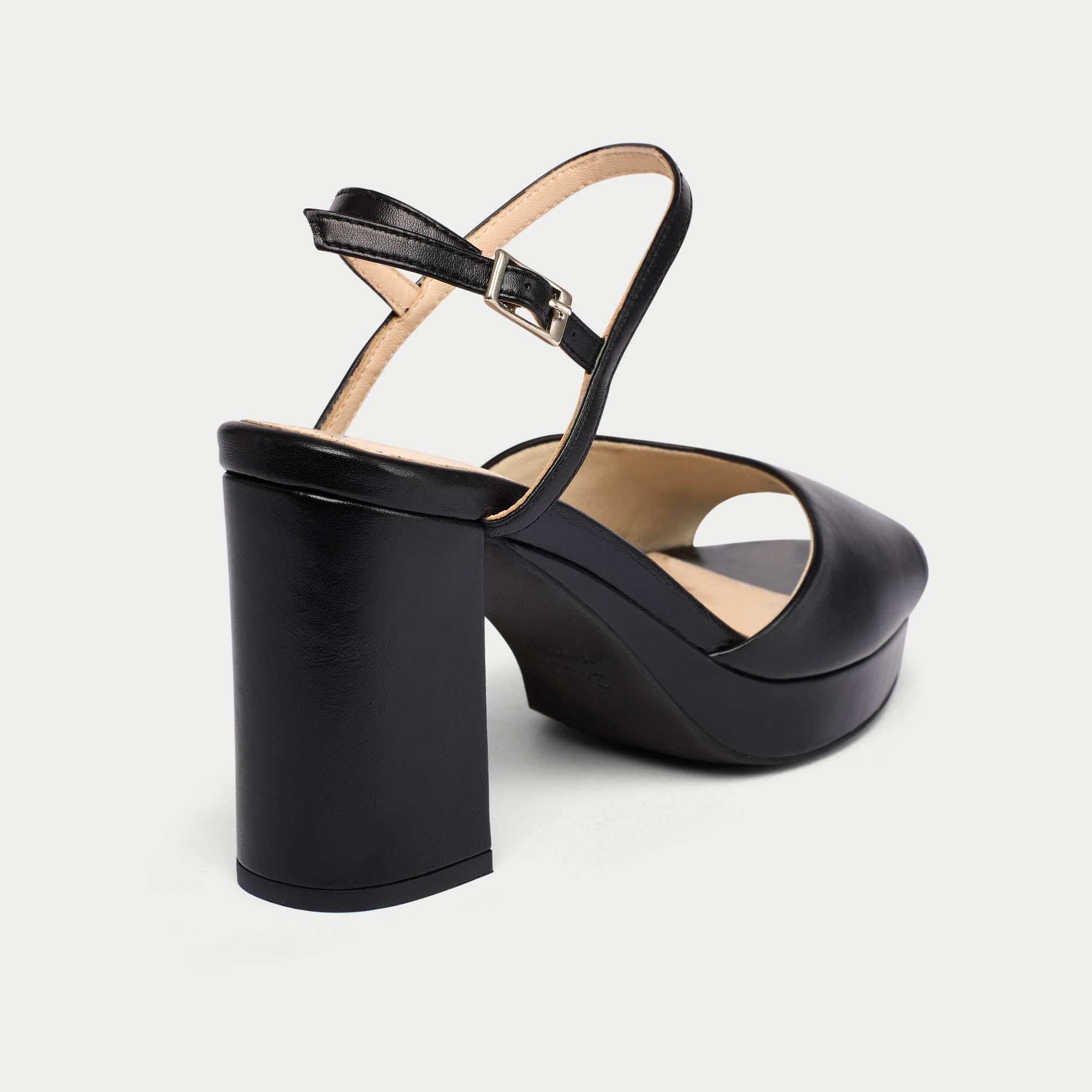 Black platform sandal on a light gray background