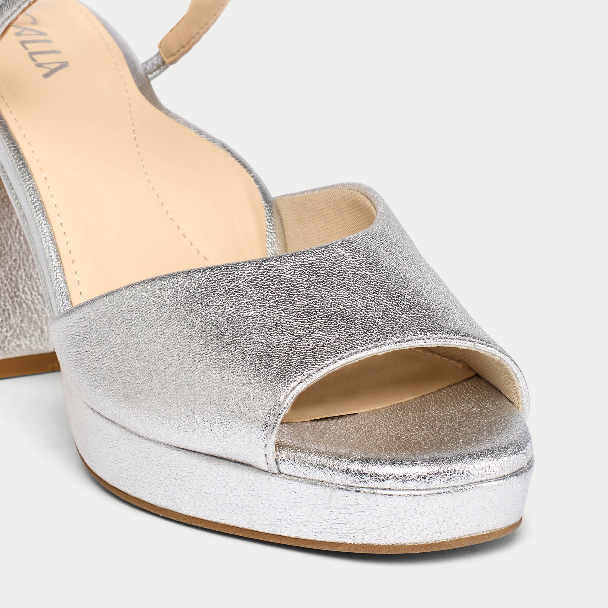 Silver open-toe sandal on a light gray background