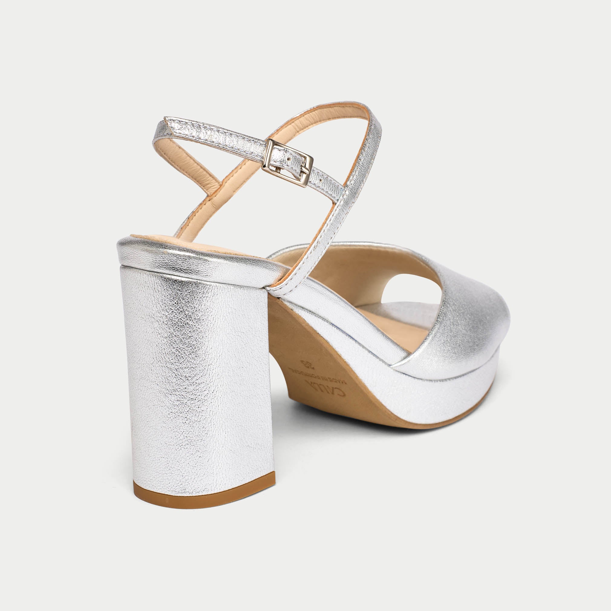 Silver wedge sandal on a white background