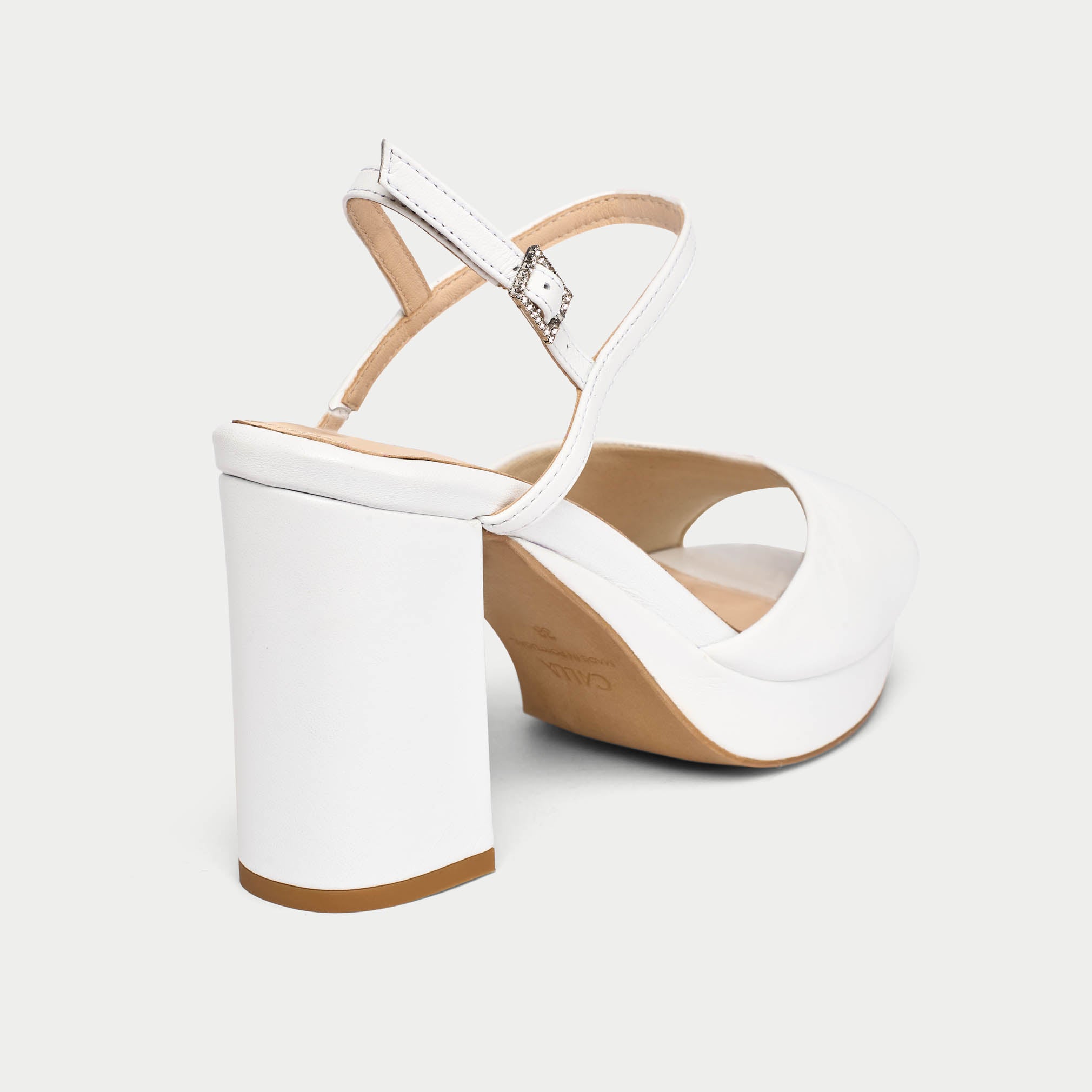 White wedge sandal with a wooden sole on a light gray background