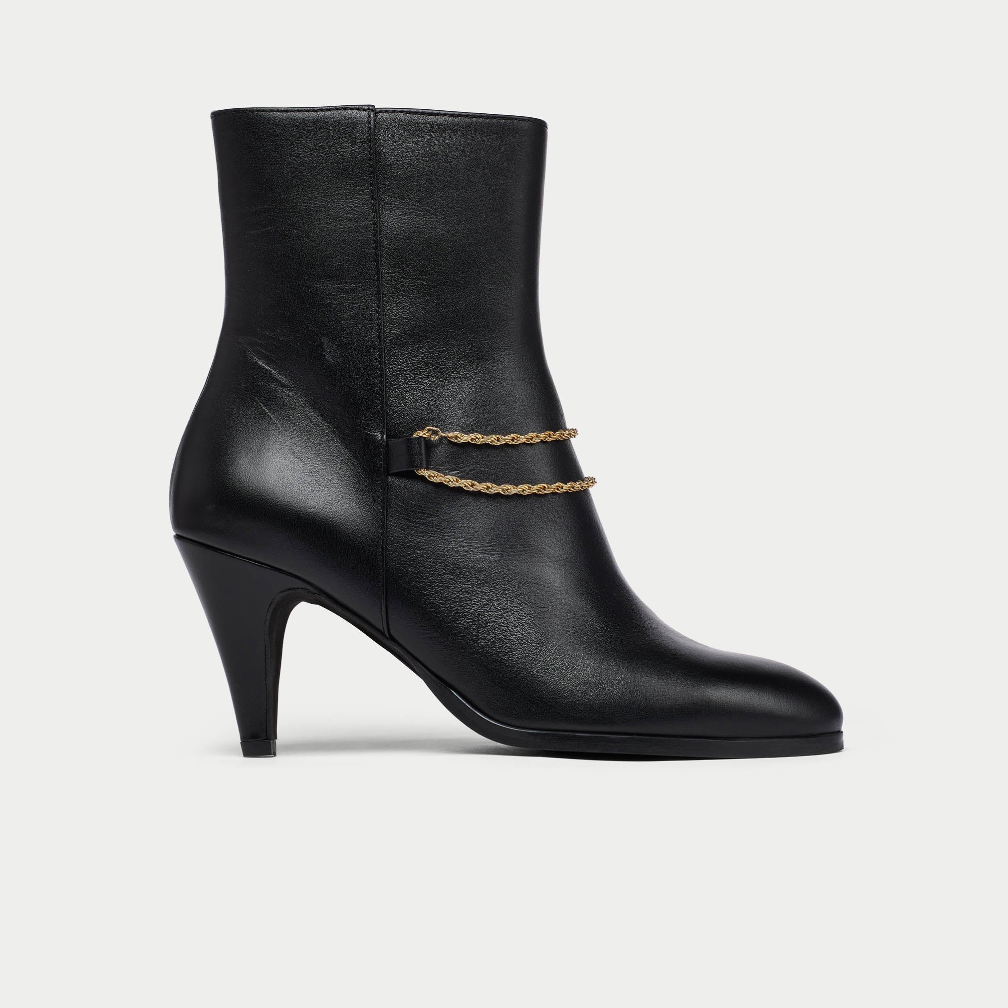 Maya Black ankle boot for wide feet with a gold chain on a light gray background