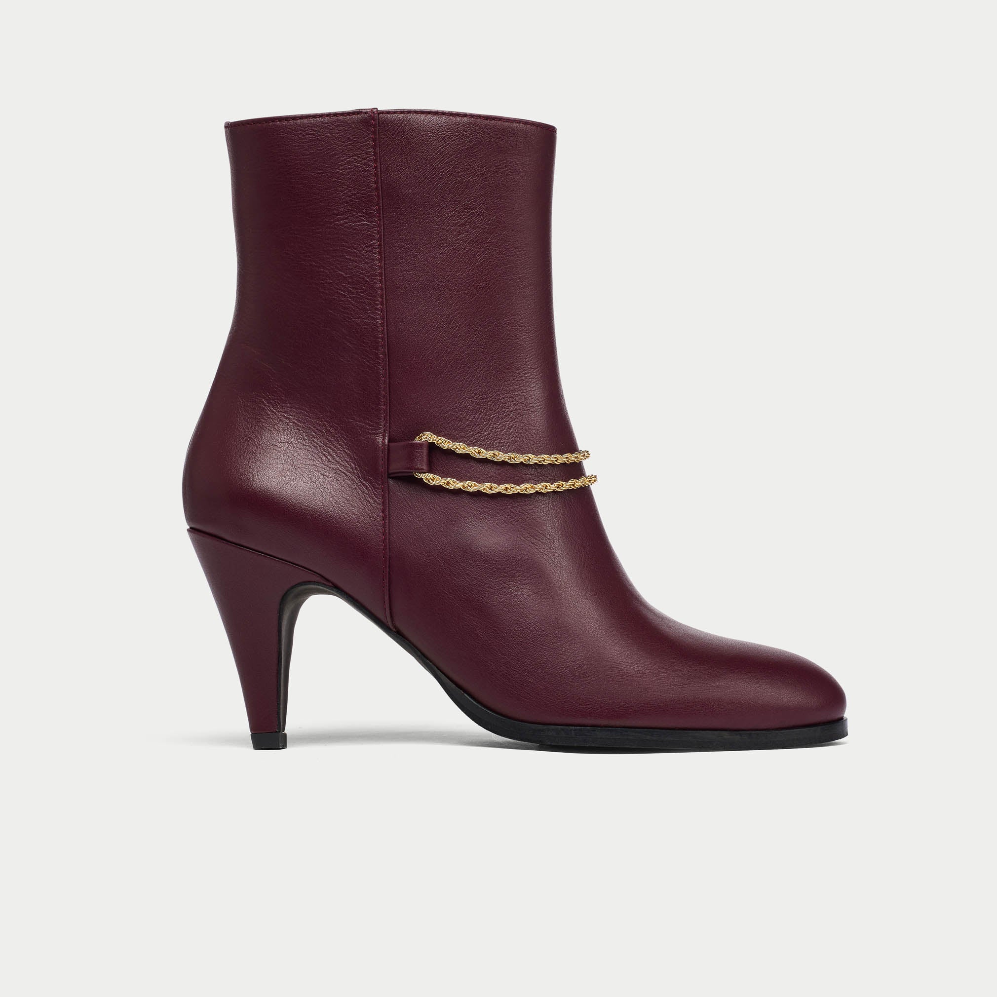 Maya cherry leather boot with gold chain detail on a white background side view