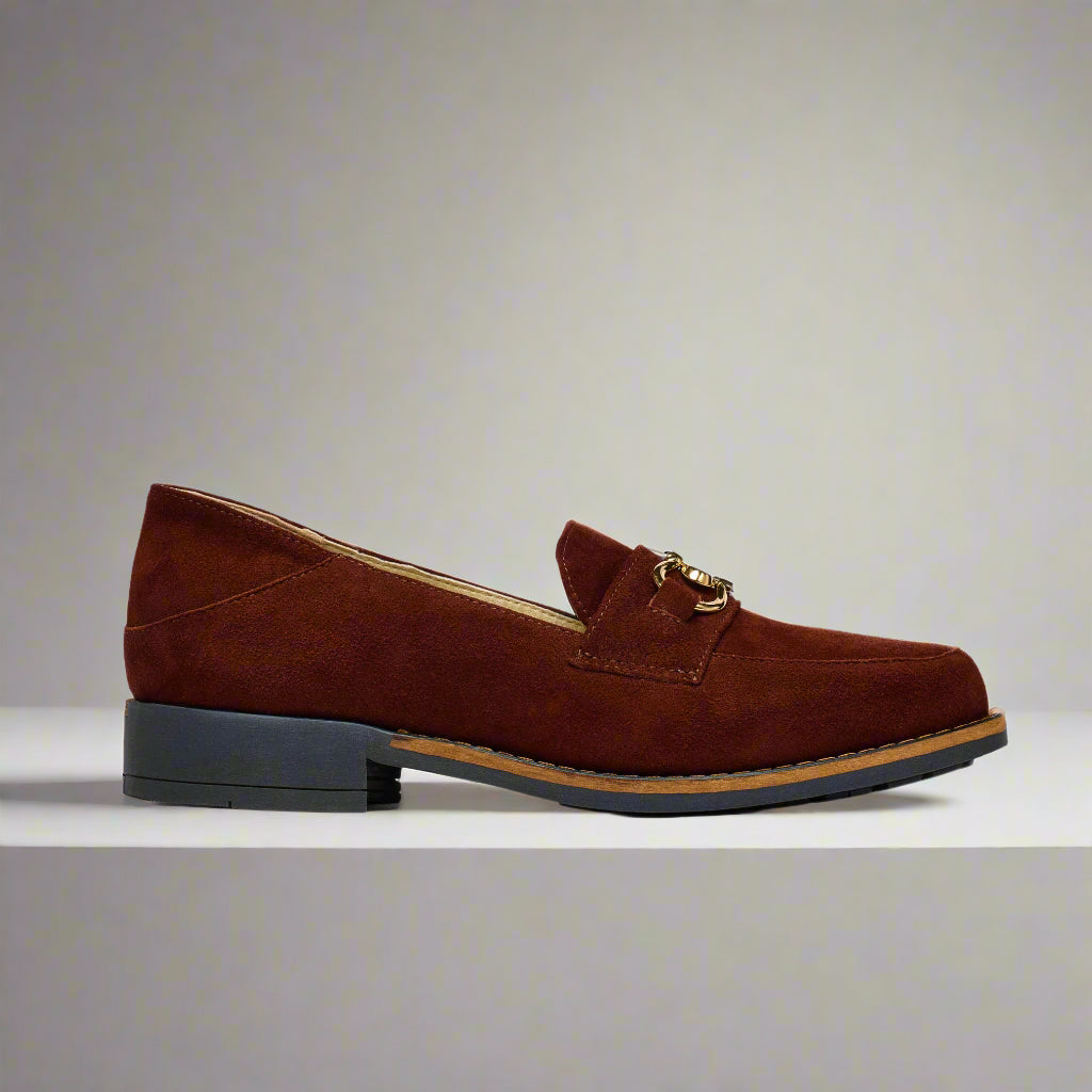 Brown suede loafer shoe on a light gray background
