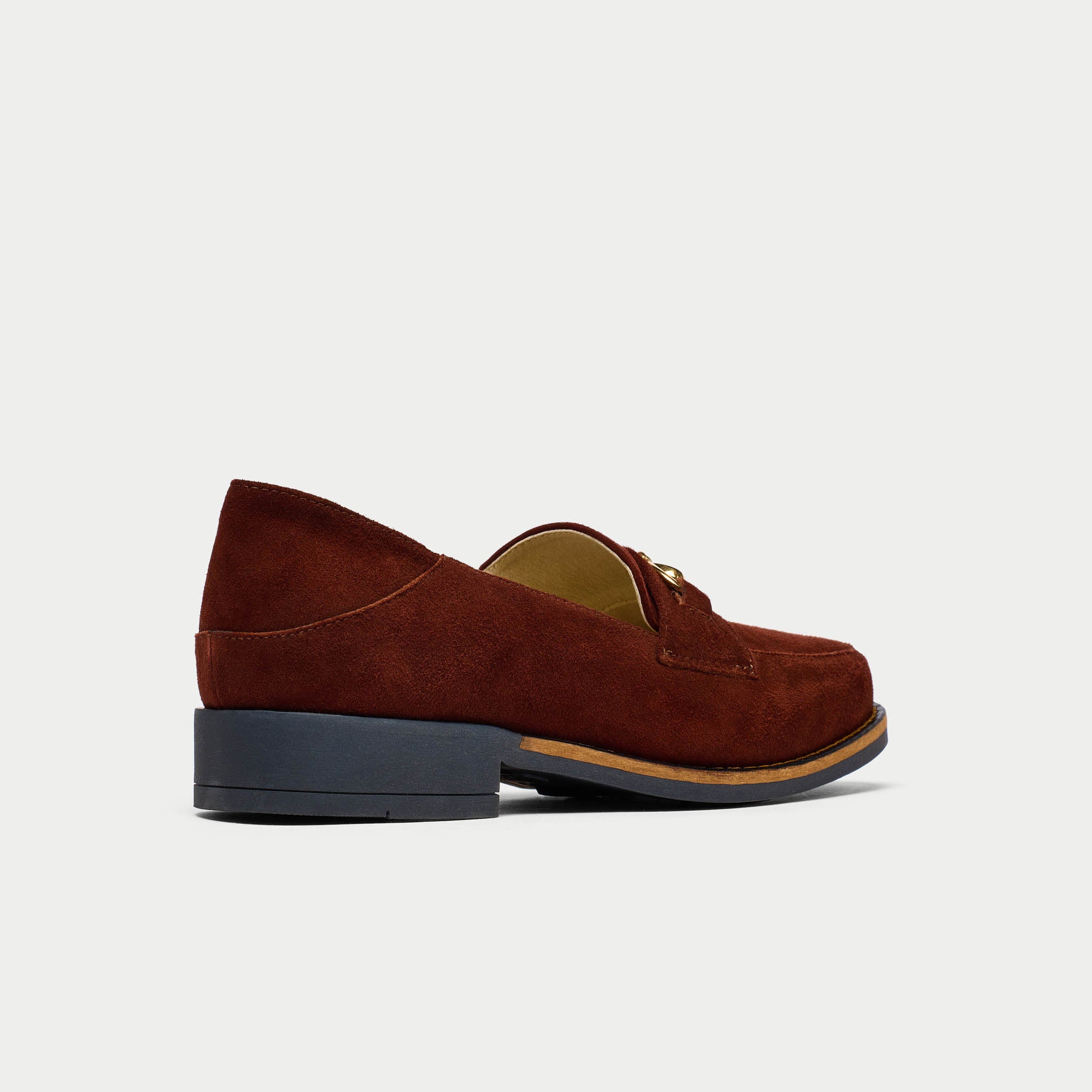 Brown suede loafer shoe on a light gray background