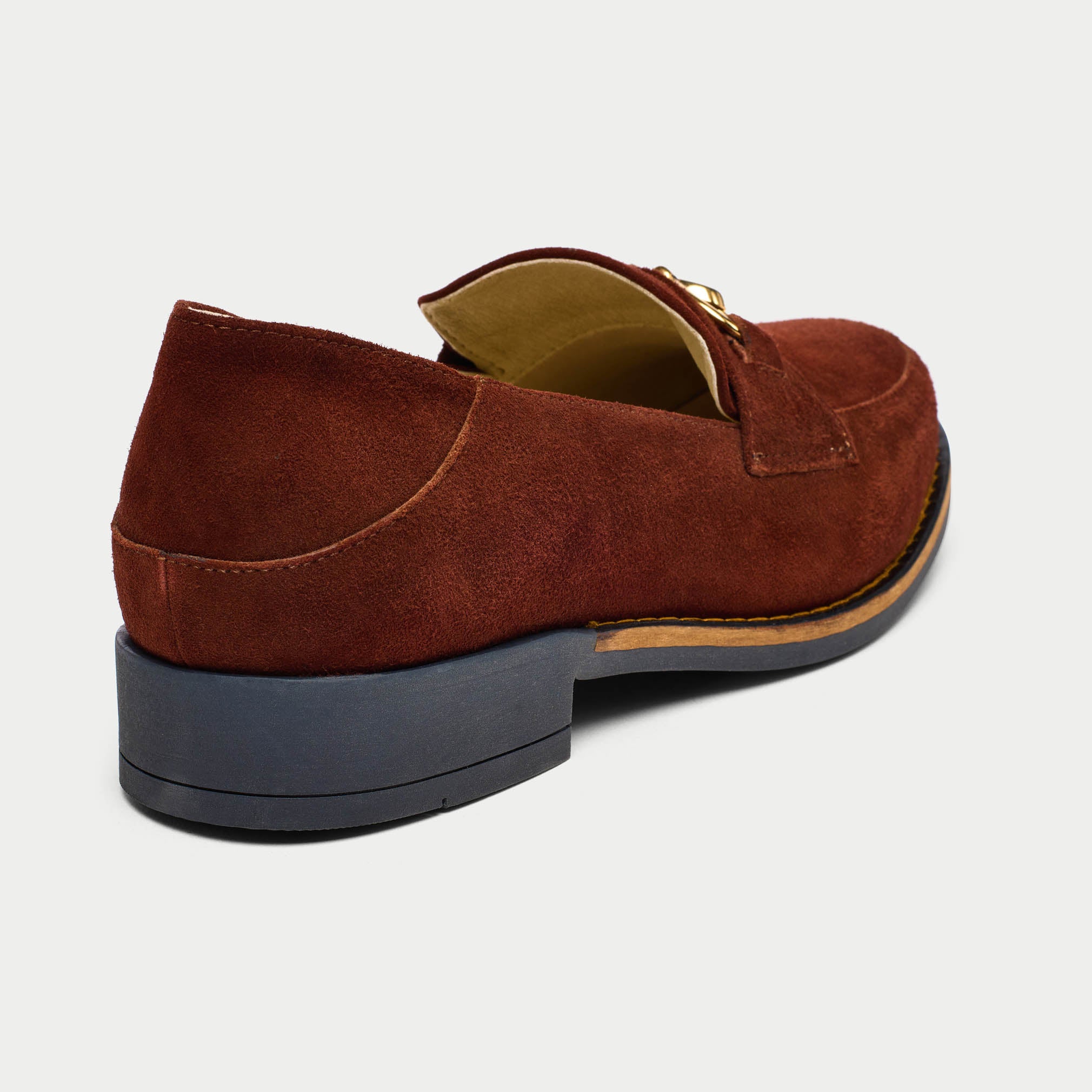 Brown suede loafer shoe on a light gray background