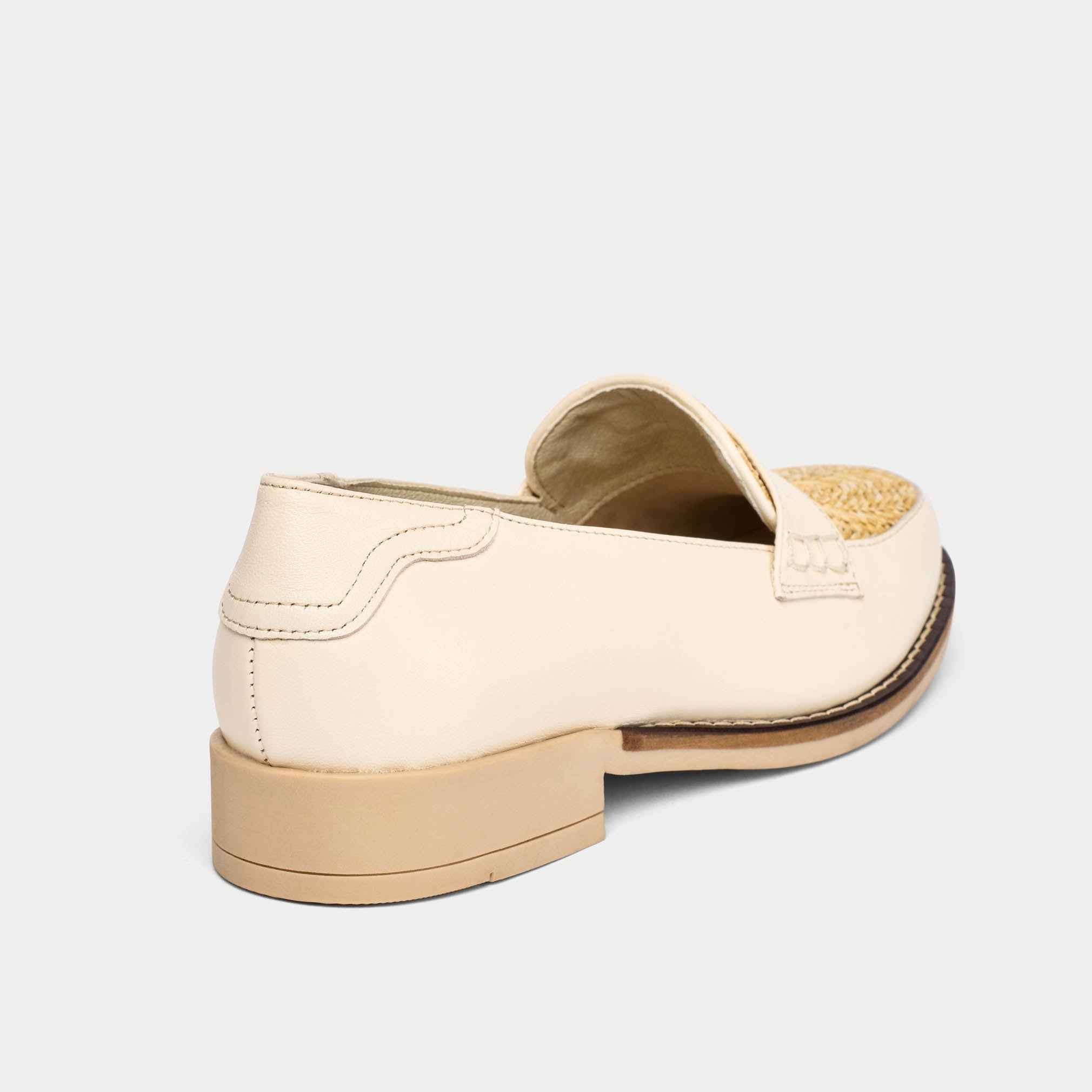 Beige clog shoe on a light beige background