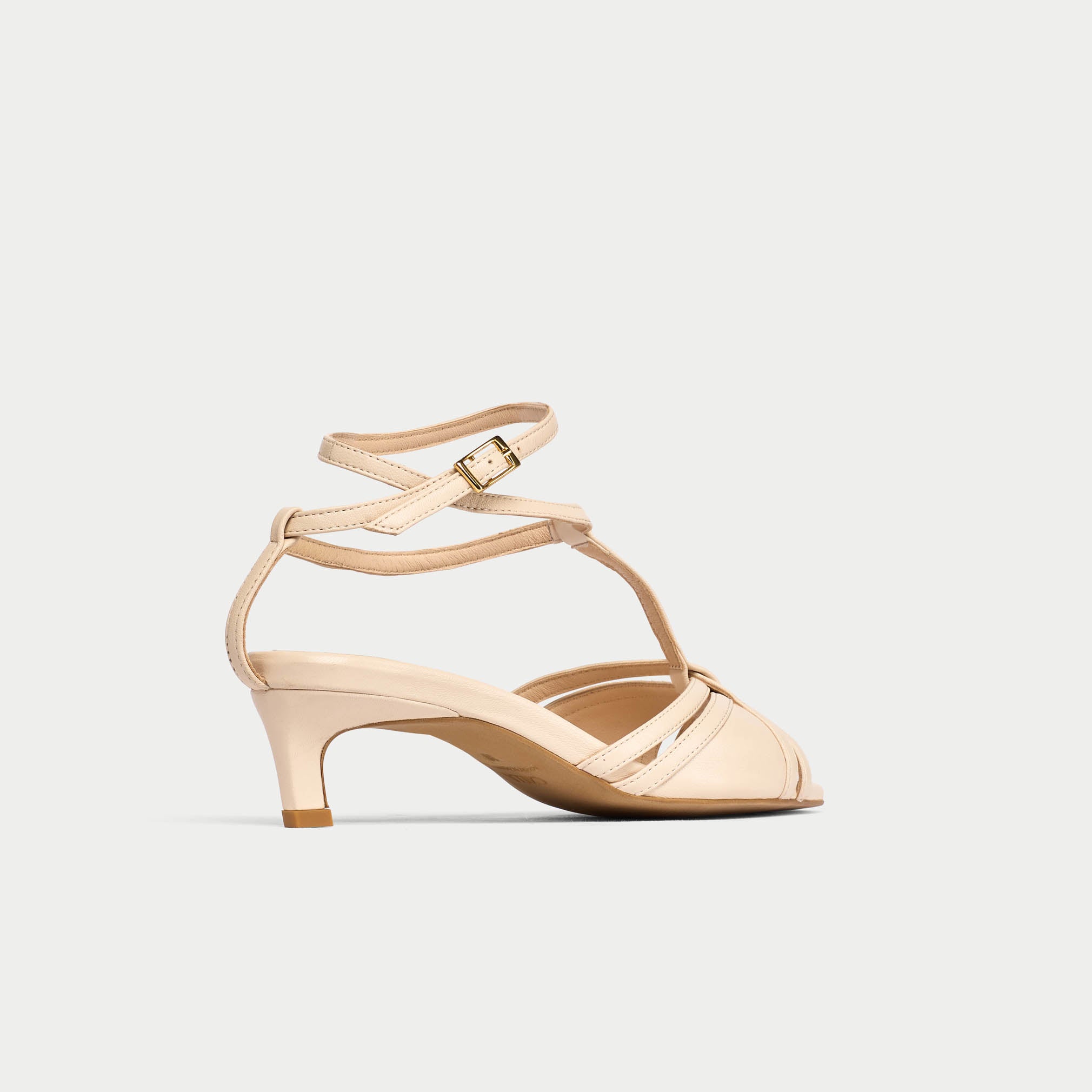 Beige sandal with a strap design on a light gray background