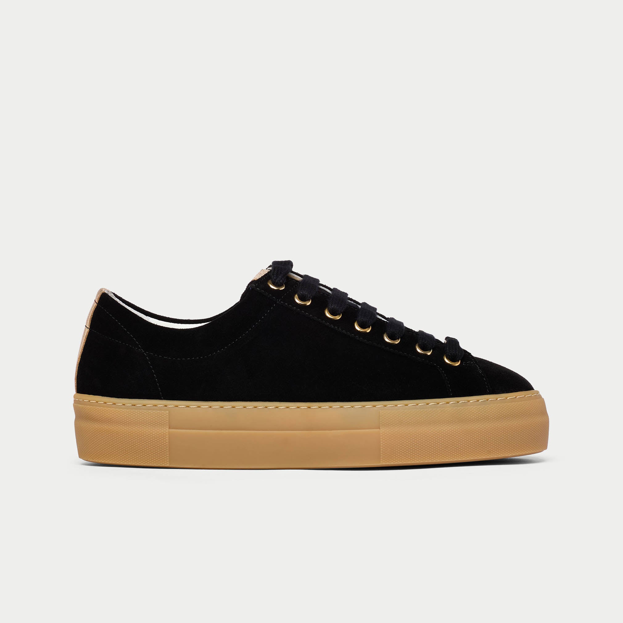 Black Saturn sneaker with tan sole on a light gray background side view