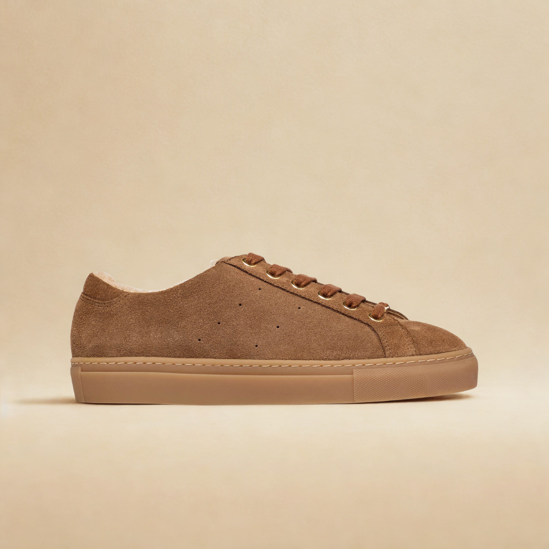 Brown suede sneaker on a beige background