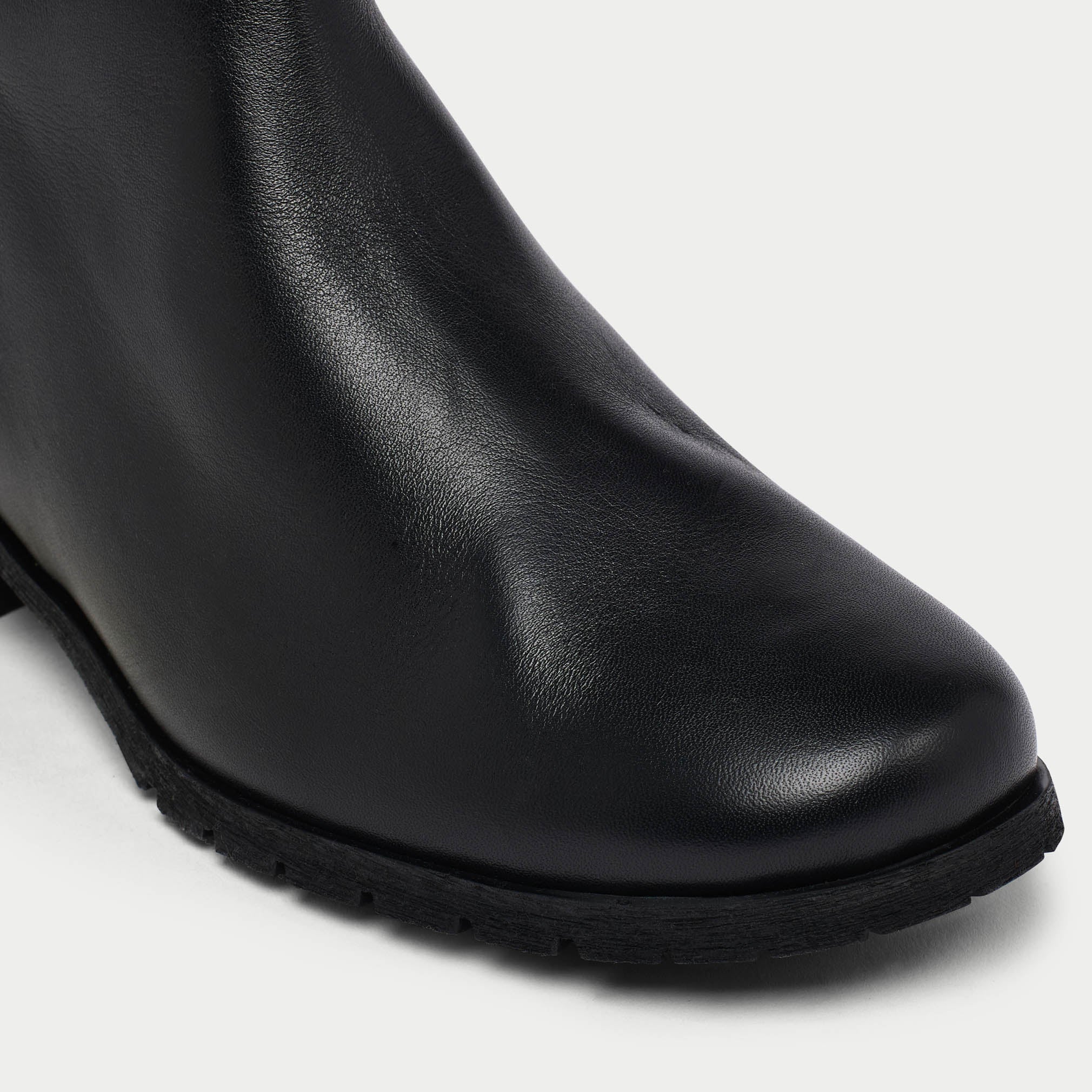 Black leather ankle boot on a white background