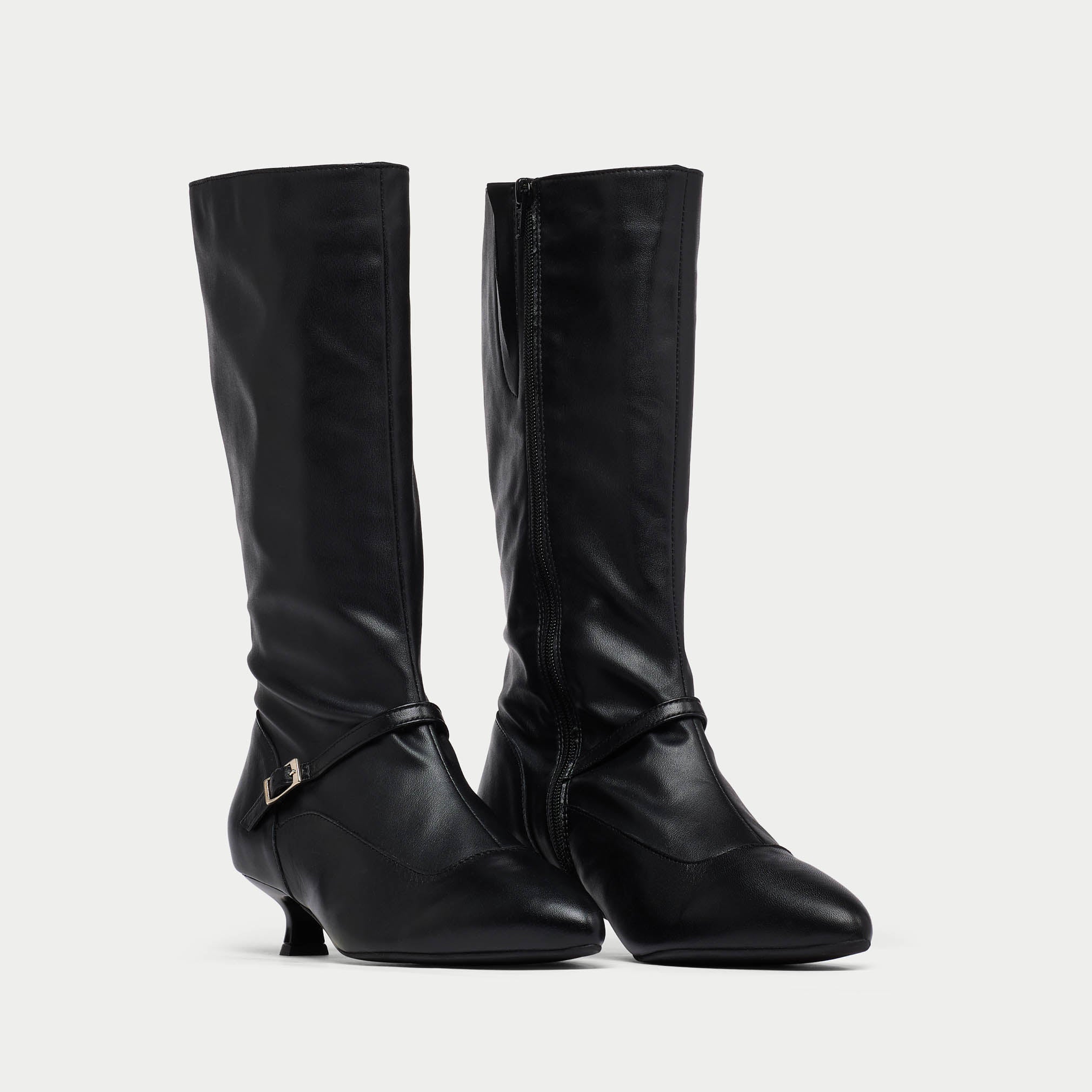 Pair of black Veronica knee-high boots with a slight heel on a light gray background